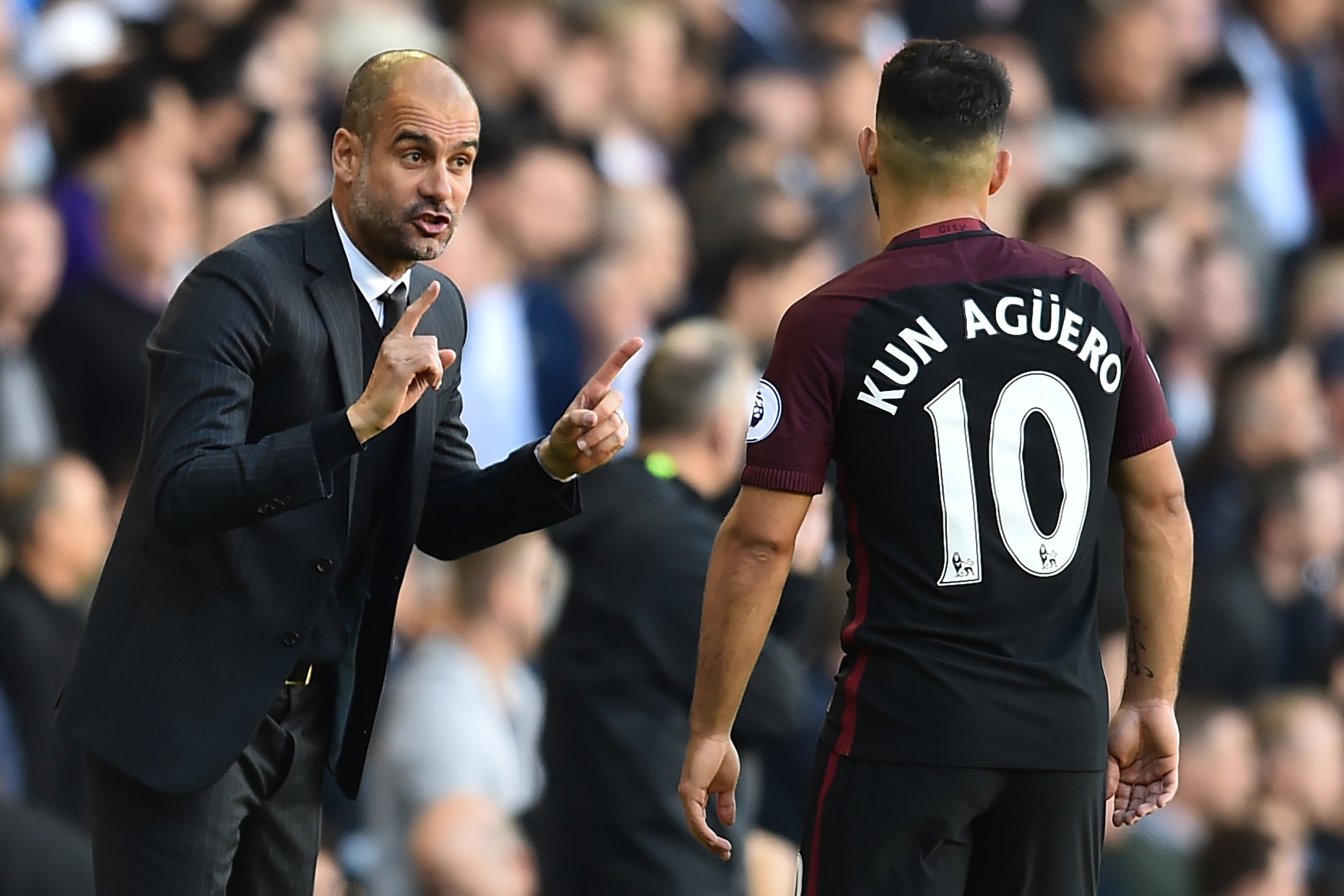 Manchester City's Spanish manager Pep Guardiola (L) gestures to Manchester City's Argentinian striker Sergio Aguero during the English Premier League football match between Tottenham Hotspur and Manchester City at White Hart Lane in London, on October 2, 