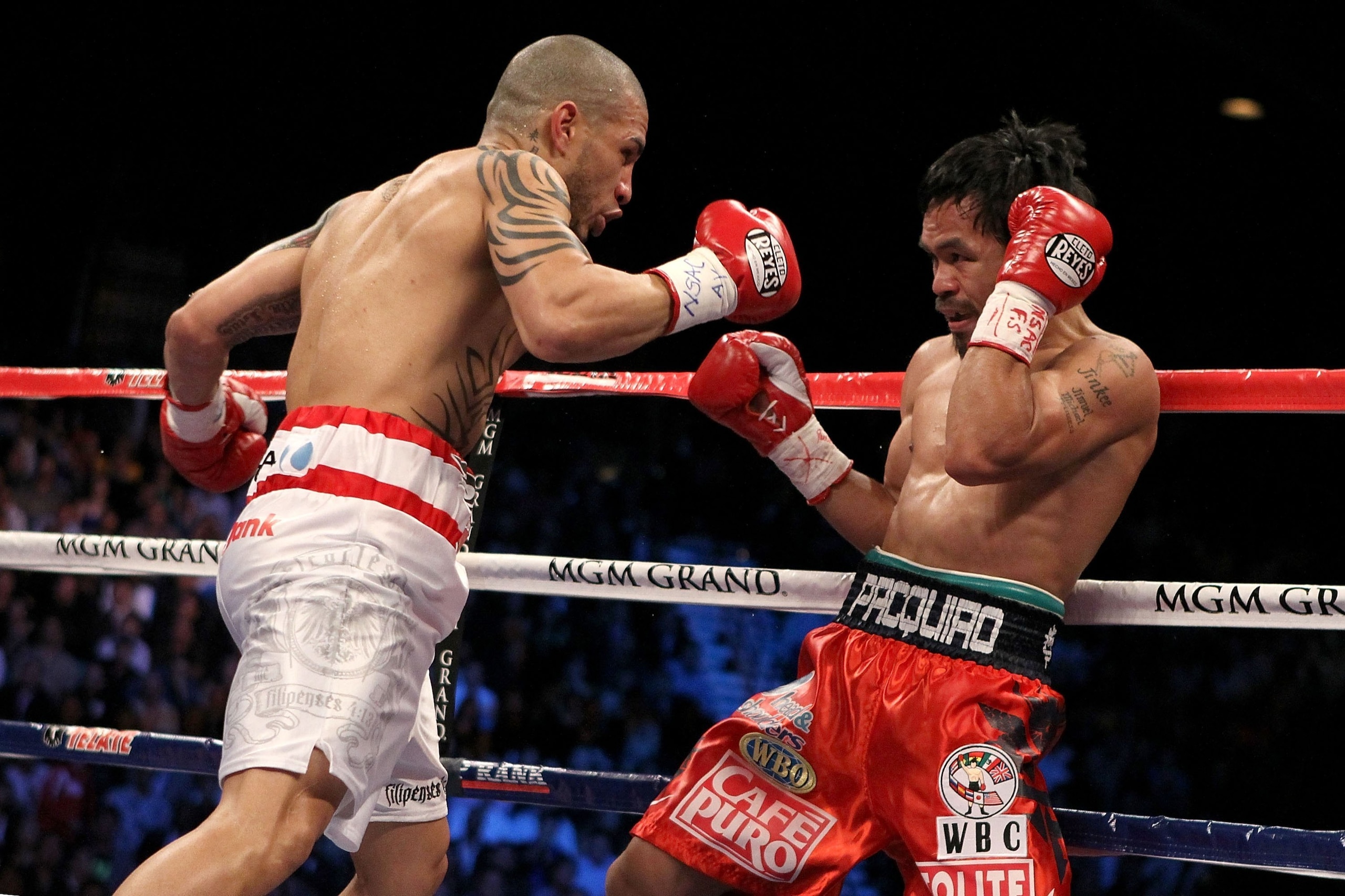 LAS VEGAS - NOVEMBER 14: (L-R) Miguel Cotto of Puerto Rico throws a right to the head of Manny Pacquiao during their WBO welterweight title fight at the MGM Grand Garden Arena on November 14, 2009 in Las Vegas, Nevada. (Photo by Al Bello/Getty Images) LAS VEGAS - NOVEMBER 14: (L-R) Miguel Cotto of Puerto Rico throws a right to the head of Manny Pacquiao during their WBO welterweight title fight at the MGM Grand Garden Arena on November 14, 2009 in Las Vegas, Nevada. (Photo by Al Bello/Getty Images)