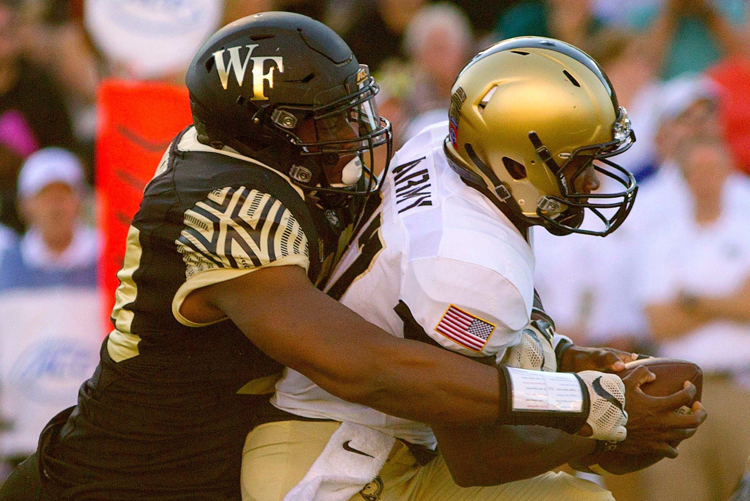 Oct 29, 2016; Winston-Salem, NC, USA; Army Black Knights quarterback Ahmad Bradshaw (17) is brought down by Wake Forest Demon Deacons defensive lineman Duke Ejiofor (53) during the first half at BB&T Field. Mandatory Credit: Joshua S. Kelly-USA TODAY Spor