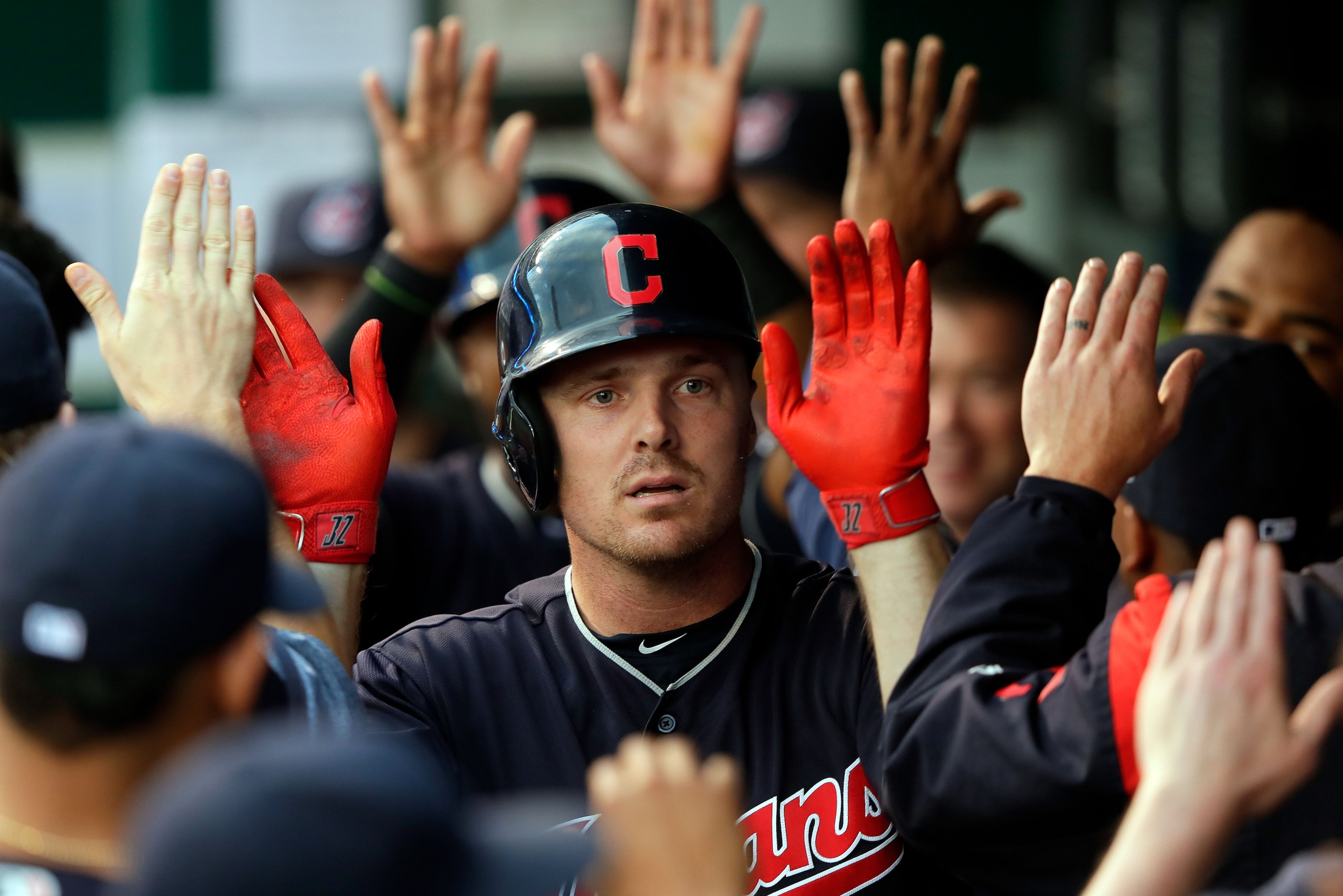 KANSAS CITY, MO - AUGUST 18:  Jay Bruce #32 of the Cleveland Indians is congratulated by teammates in the dugout after hitting a home run during the 1st inning of the game against the Kansas City Royals at Kauffman Stadium on August 18, 2017 in Kansas Cit