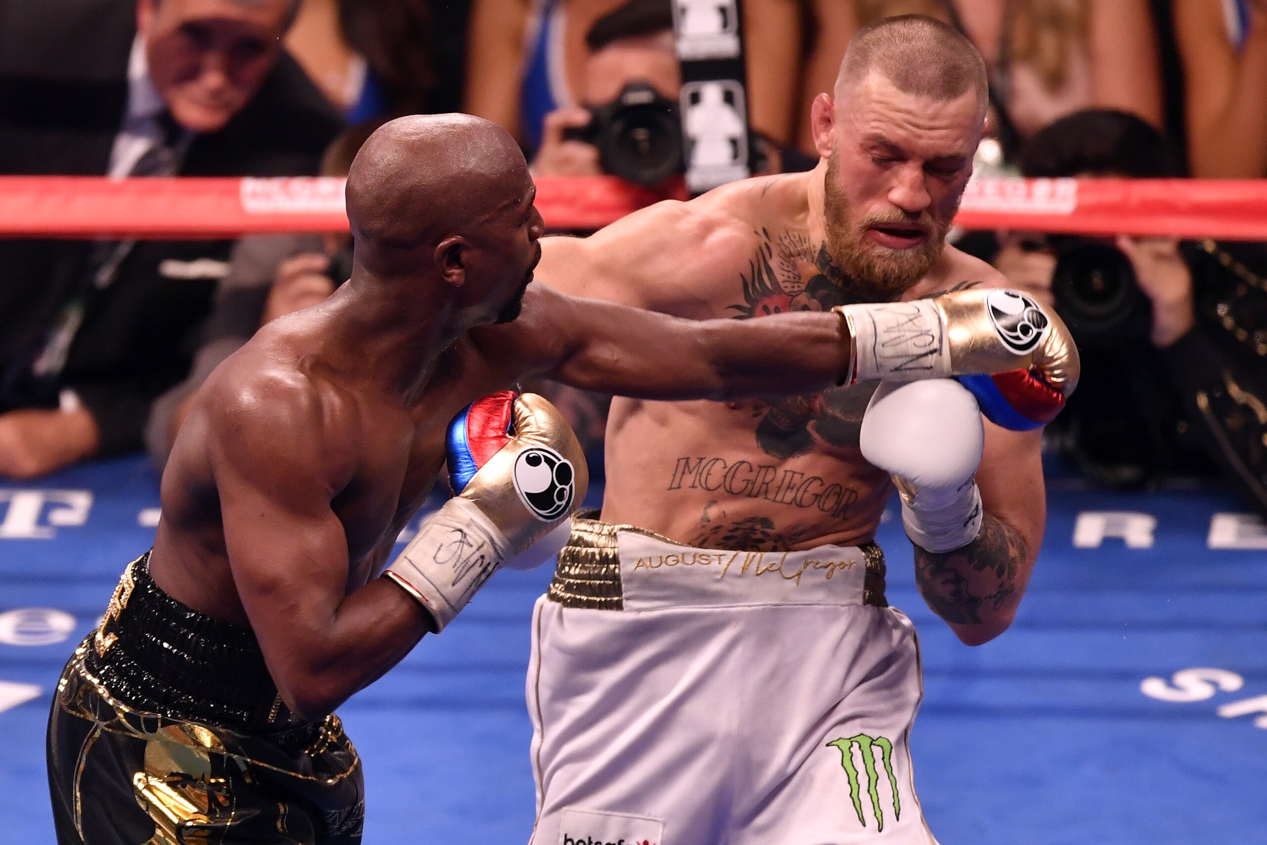 LAS VEGAS, NV - AUGUST 26:  (L-R) Floyd Mayweather Jr. punches Conor McGregor in their super welterweight boxing match at T-Mobile Arena on August 26, 2017 in Las Vegas, Nevada. Mayweather won by 10th-round TKO. (Photo by Jeff Bottari/Zuffa LLC/Zuffa LLC 