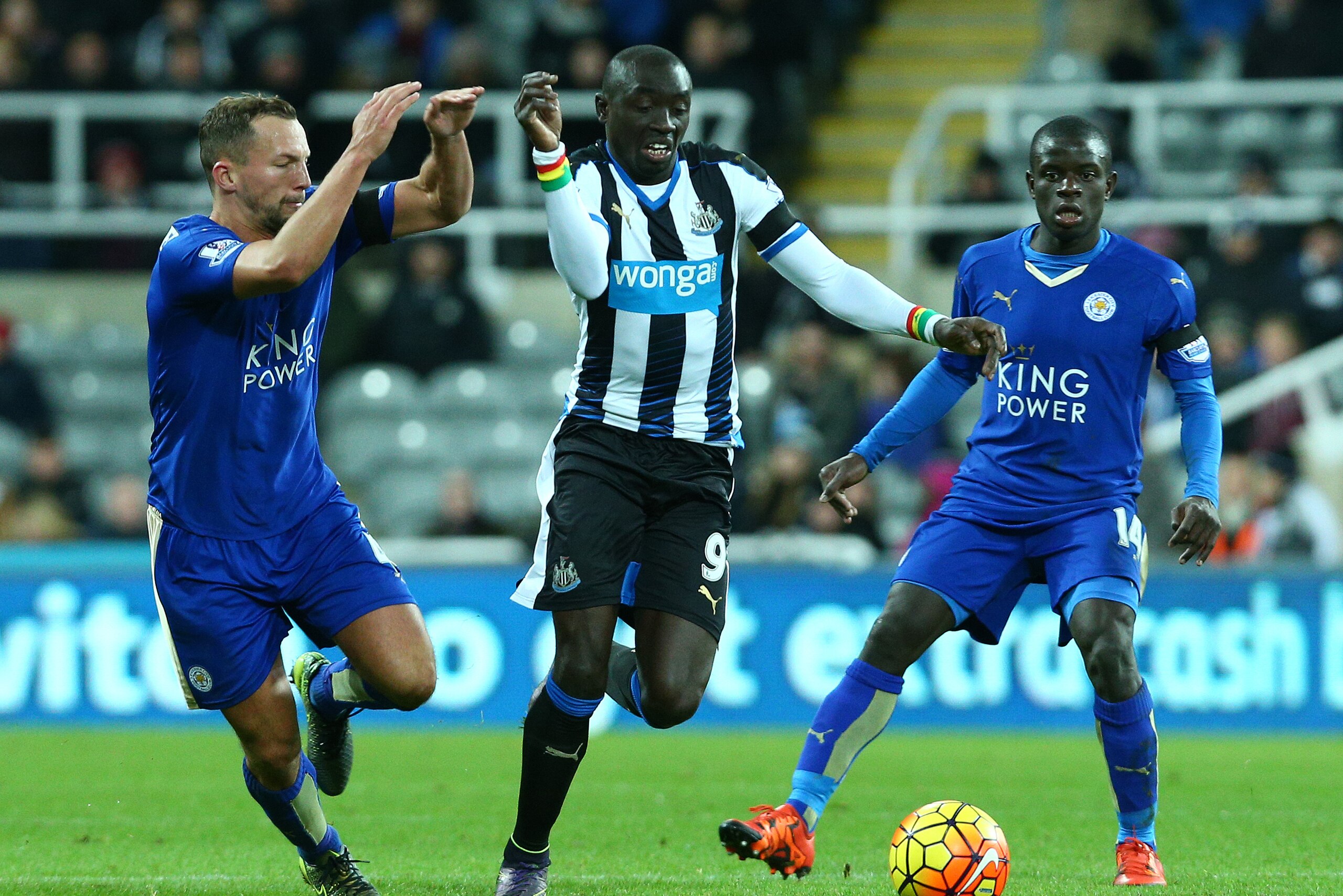 NEWCASTLE UPON TYNE, ENGLAND - NOVEMBER 21 : Papiss Cisse of Newcastle is tracked by Danny Drinkwater and N'Golo Kante of Leicester during the Barclays Premier League match between Newcastle United FC and Leicester City FC at St James' Park on November 21