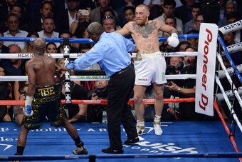 Aug 26, 2017; Las Vegas, NV, USA; Floyd Mayweather Jr. (black trunks) is taunted by Conor McGregor (white trunks) during their boxing match at T-Mobile Arena. Mayweather won via tenth round TKO. Mandatory Credit: Joe Camporeale-USA TODAY Sports