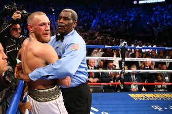 Aug 26, 2017; Las Vegas, NV, USA; Boxing referee Robert Byrd holds Conor McGregor after stopping the right in the tenth round against Floyd Mayweather Jr. in the tenth round during a boxing match at T-Mobile Arena. Mandatory Credit: Mark J. Rebilas-USA TO