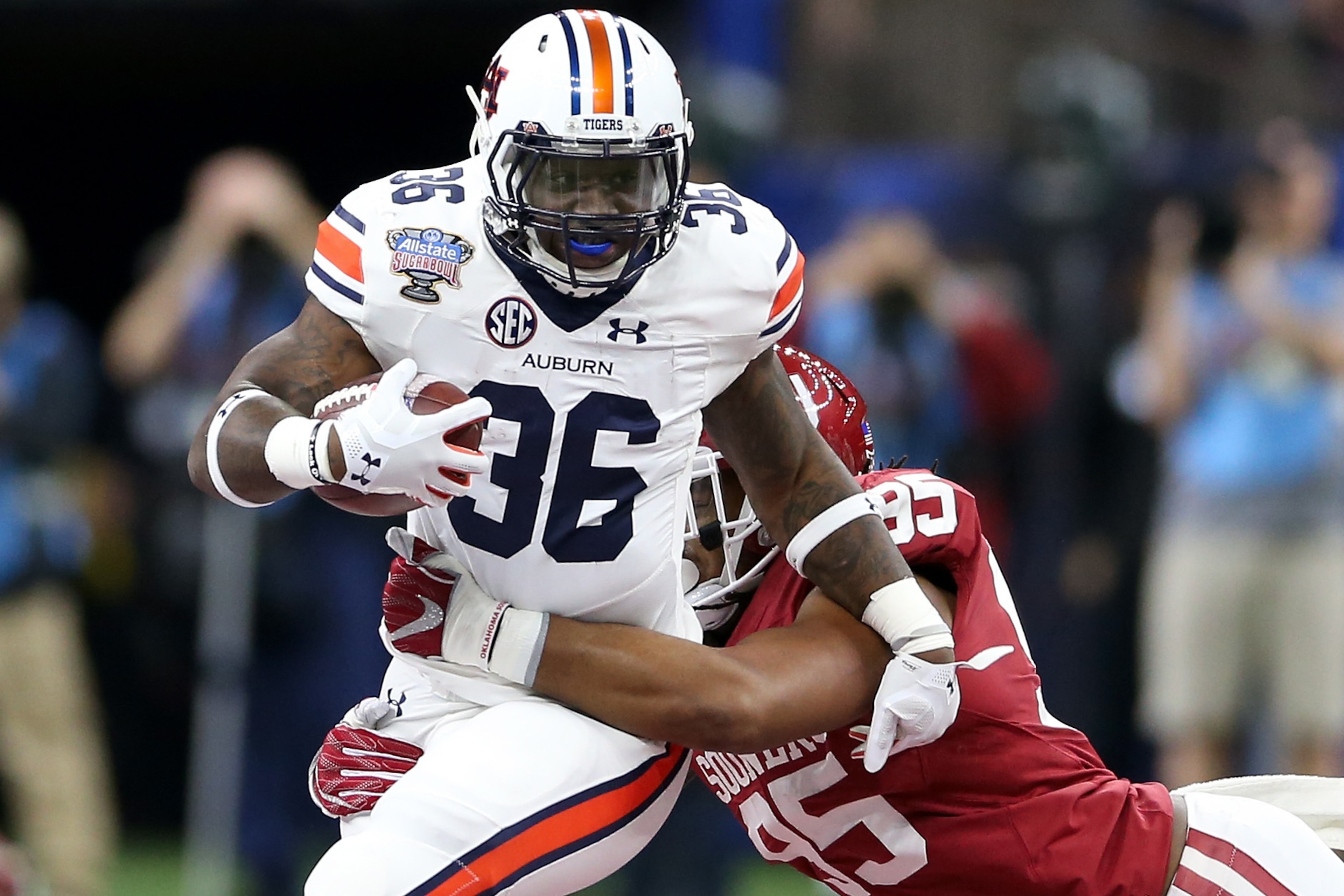 NEW ORLEANS, LA - JANUARY 02:  Kamryn Pettway #36 of the Auburn Tigers is tackled by Austin Roberts #95 of the Oklahoma Sooners during the Allstate Sugar Bowl at the Mercedes-Benz Superdome on January 2, 2017 in New Orleans, Louisiana.  (Photo by Matthew 