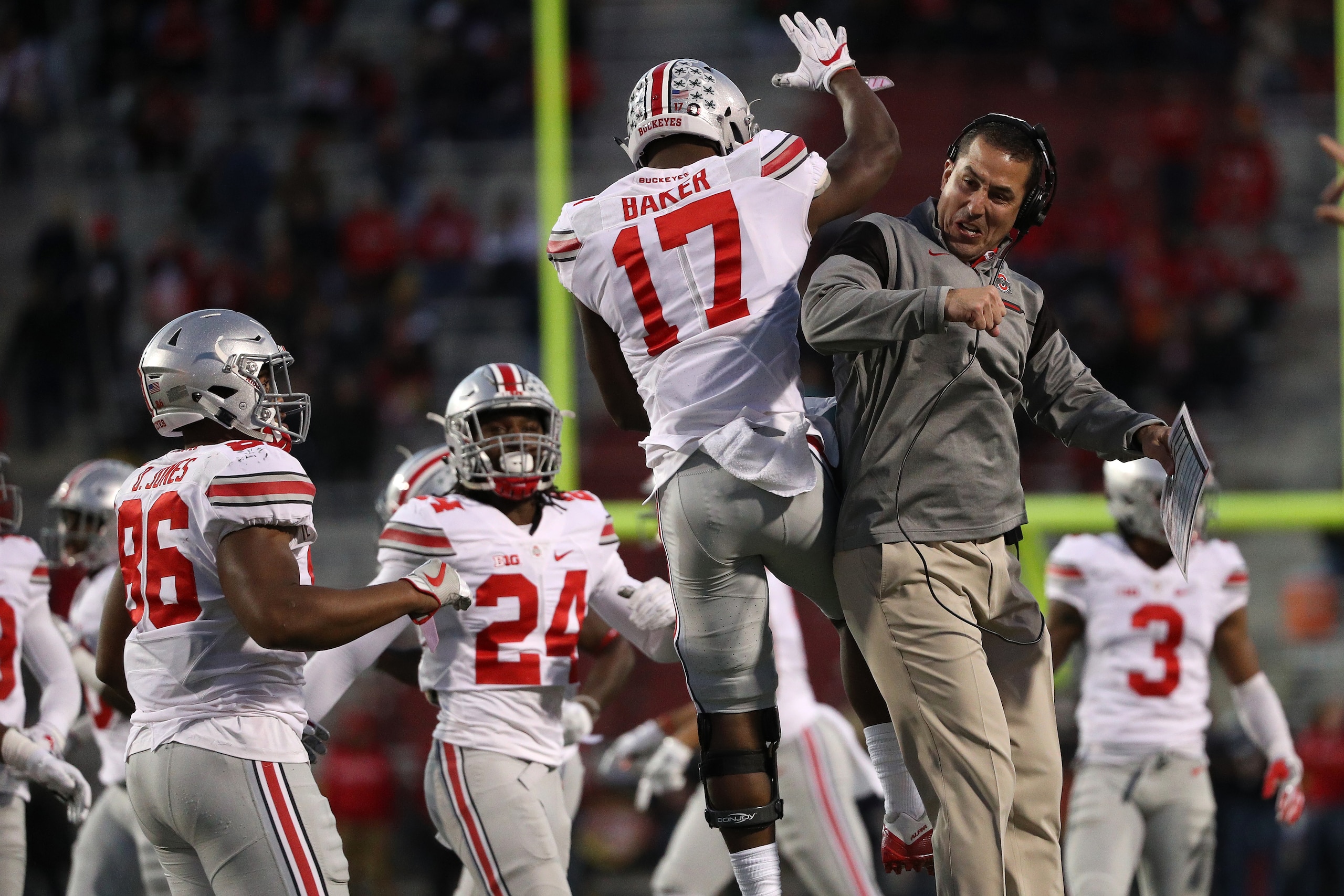 COLLEGE PARK, MD - NOVEMBER 12: Jerome Baker #17 of the Ohio State Buckeyes (L) celebrates with a coach after making a play against the Maryland Terrapins during the second quarter at Capital One Field at Maryland Stadium on November 12, 2016 in College P