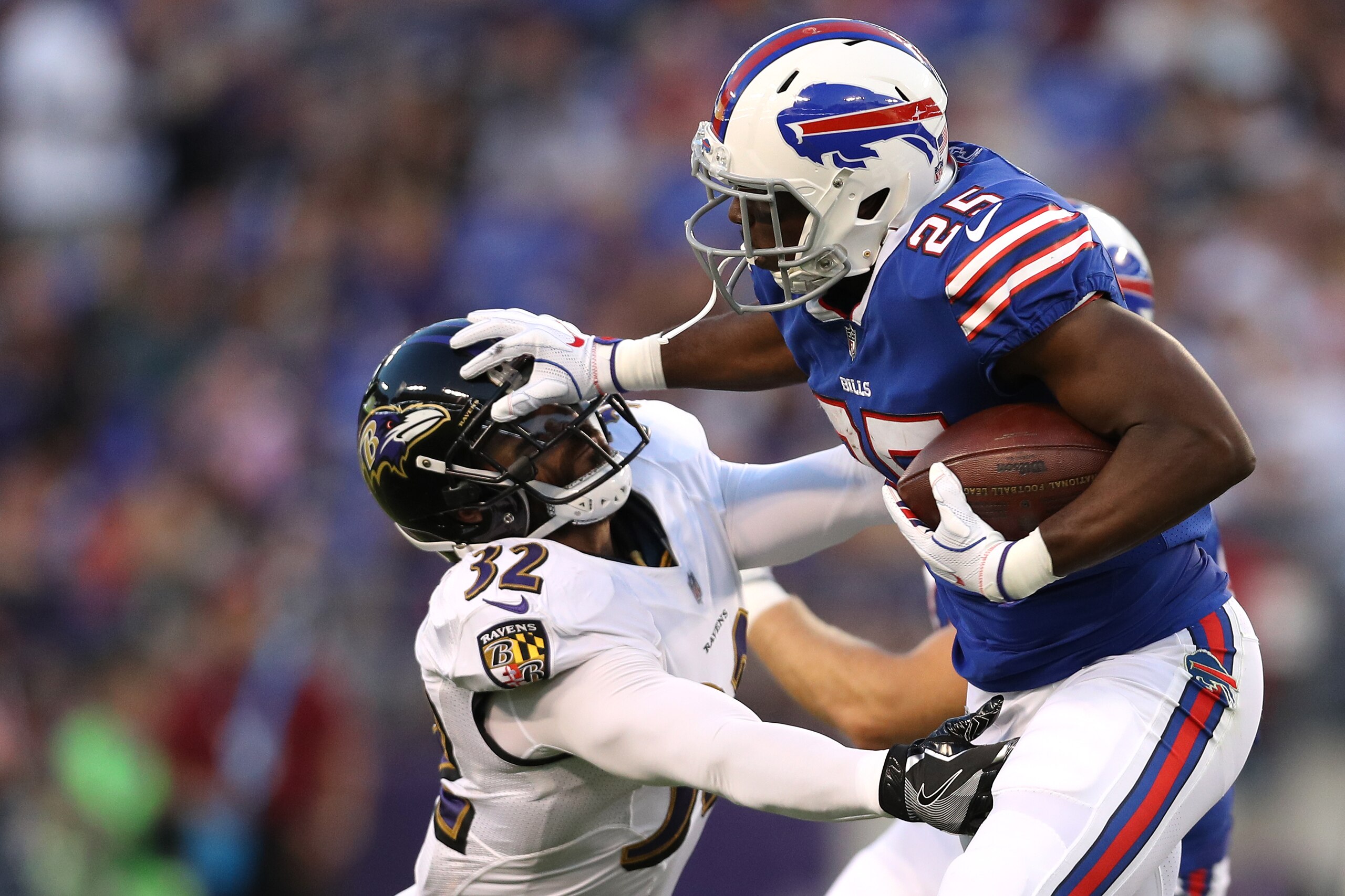BALTIMORE, MD - AUGUST 26: Running back LeSean McCoy #25 of the Buffalo Bills stiff arms strong safety Eric Weddle #32 of the Baltimore Ravens in the first half during a preseason game at M&T Bank Stadium on August 26, 2017 in Baltimore, Maryland. (Photo 