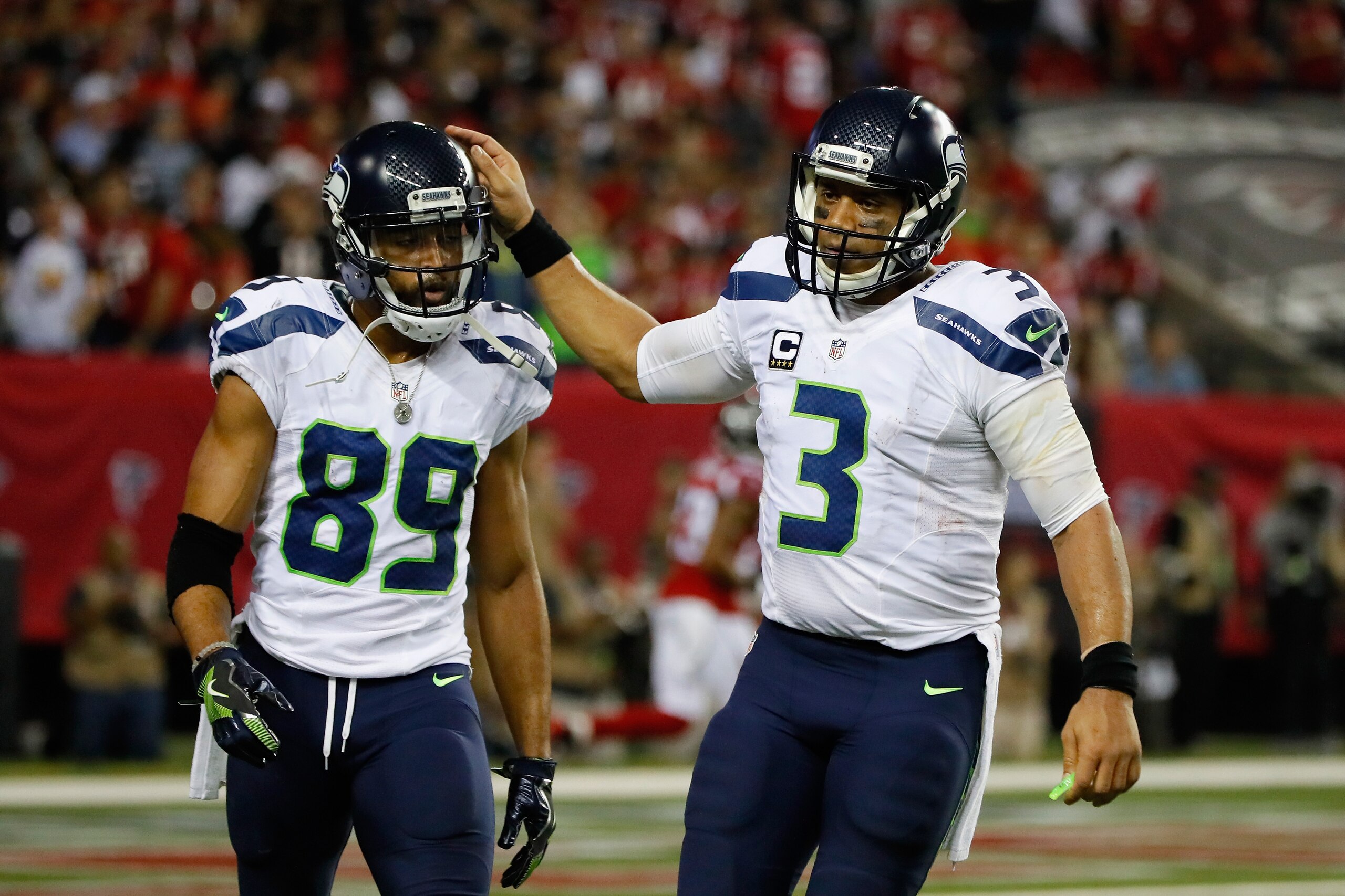 ATLANTA, GA - JANUARY 14:   Russell Wilson #3 of the Seattle Seahawks reacts with  Doug Baldwin #89 of the Seattle Seahawks against the Atlanta Falcons at the Georgia Dome on January 14, 2017 in Atlanta, Georgia.  (Photo by Kevin C. Cox/Getty Images)