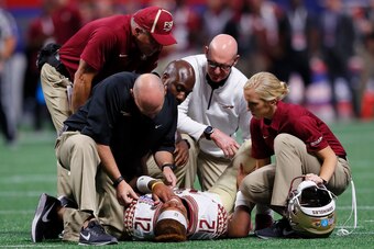 ATLANTA, GA - SEPTEMBER 02:  Deondre Francois #12 of the Florida State Seminoles is attended to by medical personnel after being injured in the fourth quarter of their game against the Alabama Crimson Tide at Mercedes-Benz Stadium on September 2, 2017 in 