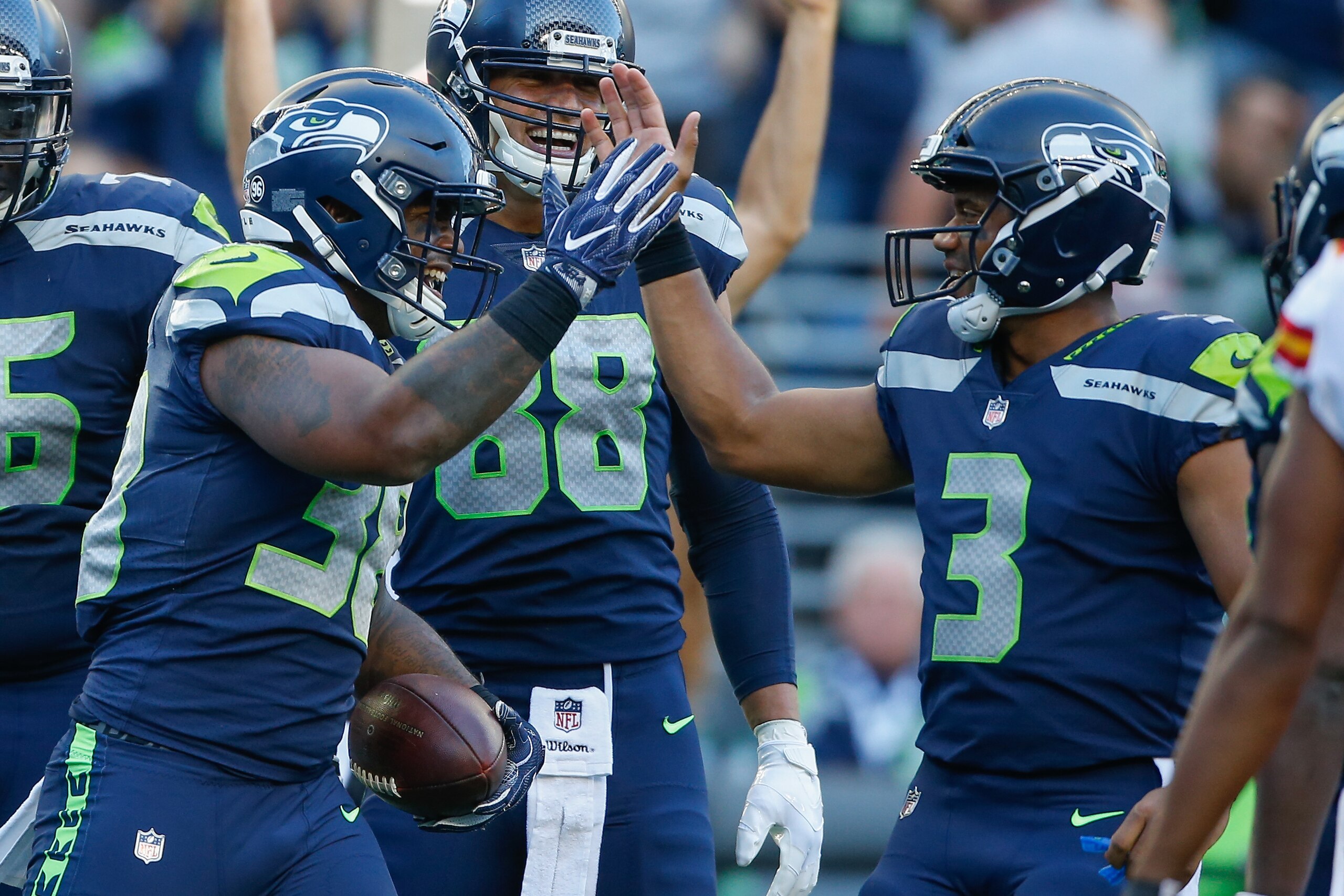SEATTLE, WA - AUGUST 25: Running back Tre Madden #38 of the Seattle Seahawks is congratulated by quarterback Russell Wilson #3 after scoring a touchdown against the Kansas City Chiefs at CenturyLink Field on August 25, 2017 in Seattle, Washington. (Photo 