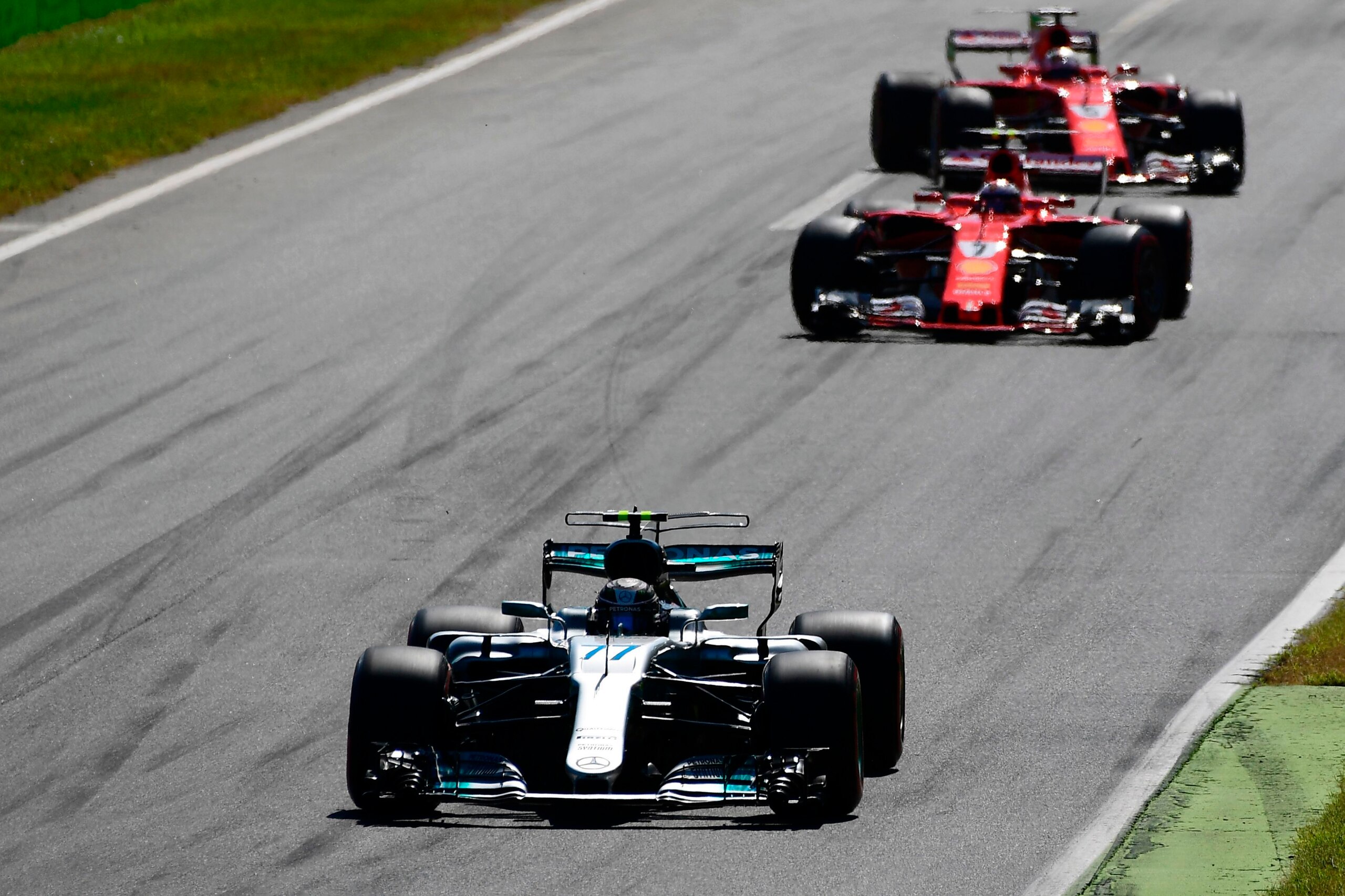 Mercedes' Finnish driver Valtteri Bottas drives ahead of Ferrari's Finnish driver Kimi Raikkonen and Ferrari's German driver Sebastian Vettel at the start of the Italian Formula One Grand Prix at the Autodromo Nazionale circuit in Monza on September 3, 20