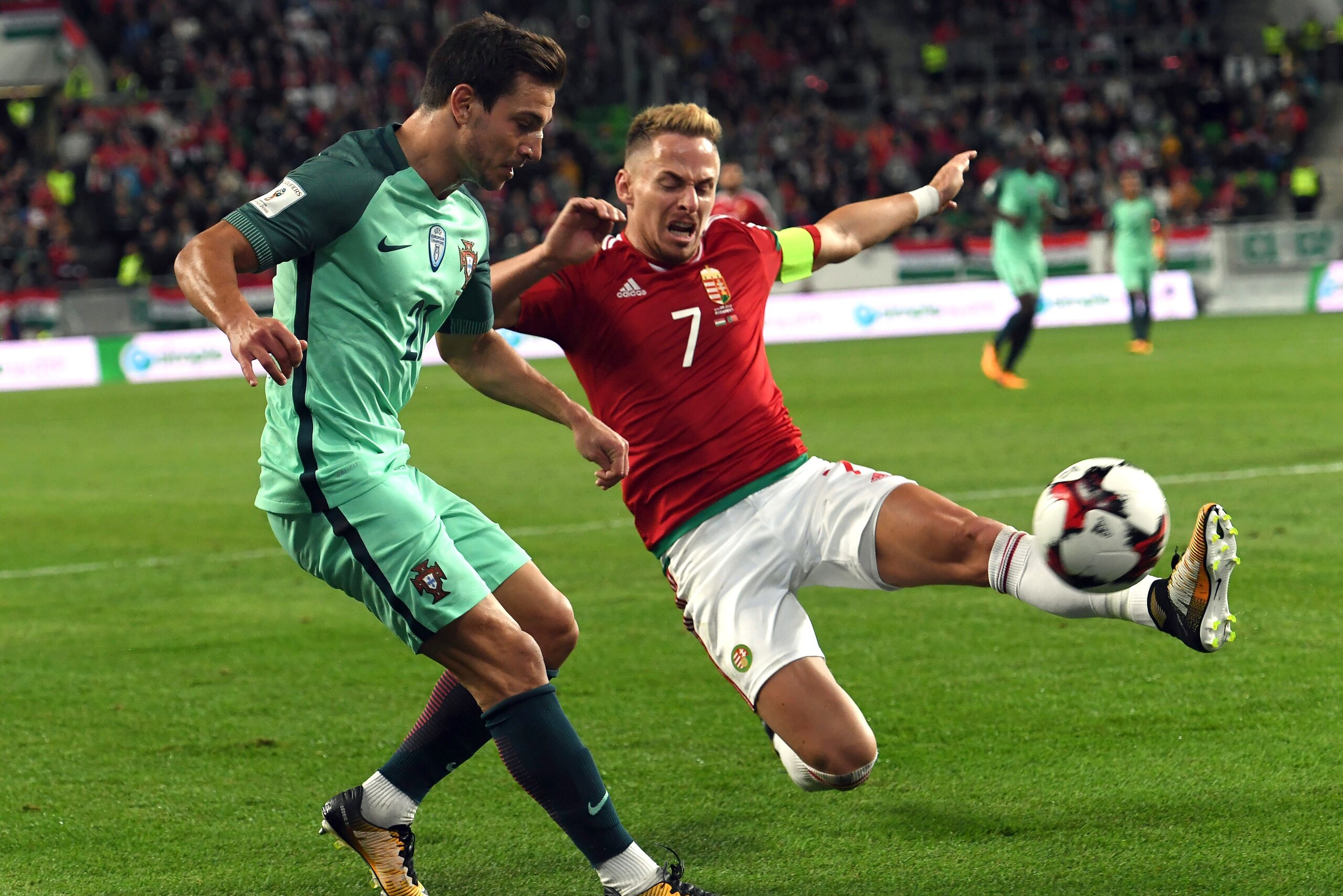 Portugal's Cedric (L) fights for the ball with Hungary's captain Balazs Dzsudzsak (R) during the FIFA World Cup 2018 qualification football match between Hungary and Portugal at The Grupama Arena in Budapest on September 3, 2017.   / AFP PHOTO / ATTILA KI