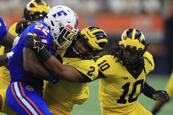 ARLINGTON, TX - SEPTEMBER 02:  Lamical Perine #22 of the Florida Gators gets stopped by Carlo Kemp #2 of the Michigan Wolverines in the first half of a game at AT&T Stadium on September 2, 2017 in Arlington, Texas.  (Photo by Ronald Martinez/Getty Images)