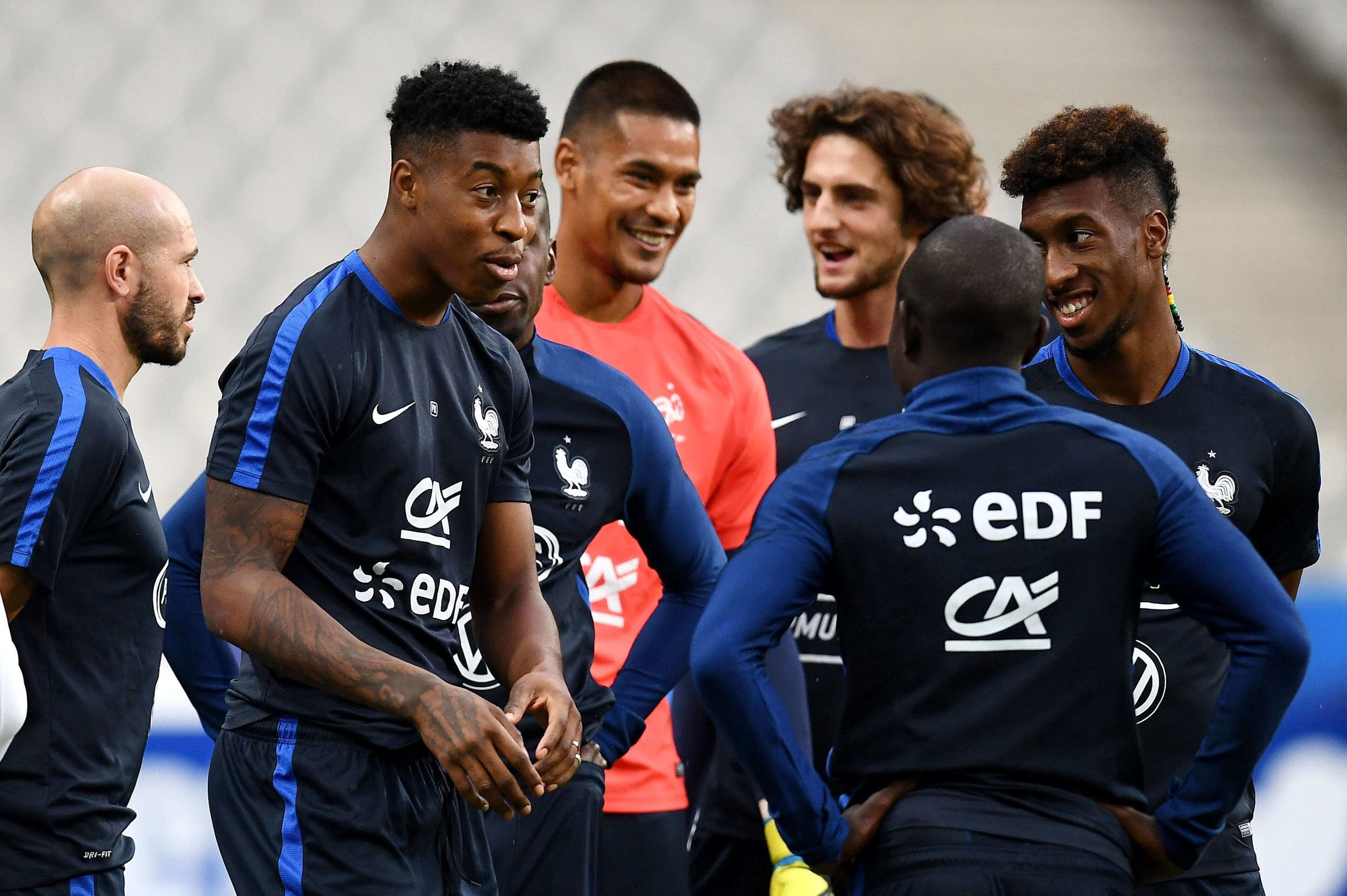 France's defender Presnel Kimpembe (L) jokes with France's midfielder N'Golo Kante (C) and France's forward Kingsley Coman (R) during a training session at the Stade de France stadium in Saint-Denis, north of Paris, on August 30, 2017 on the eve of their France's defender Presnel Kimpembe (L) jokes with France's midfielder N'Golo Kante (C) and France's forward Kingsley Coman (R) during a training session at the Stade de France stadium in Saint-Denis, north of Paris, on August 30, 2017 on the eve of their