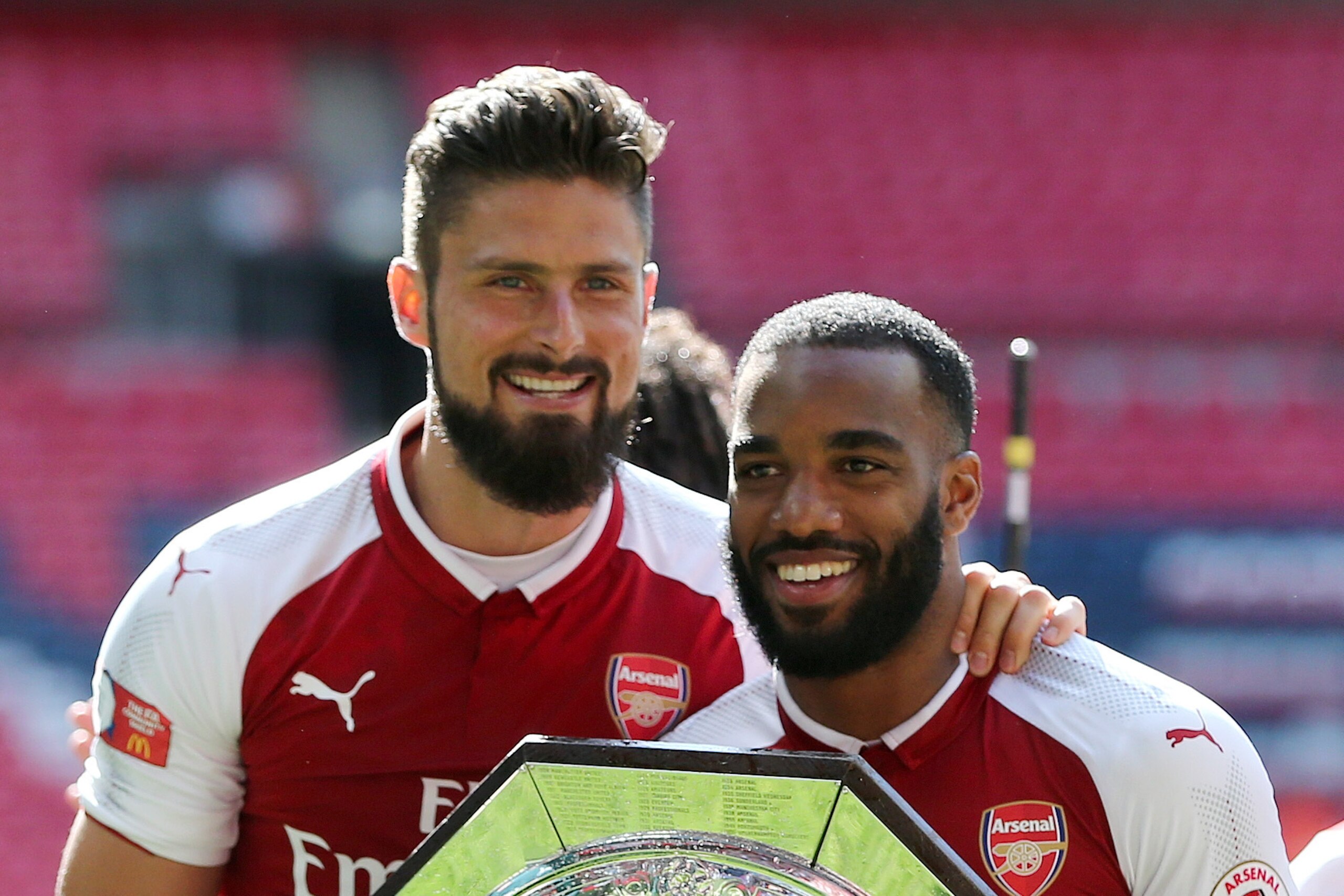 LONDON, ENGLAND - AUGUST 06: Olivier Giroud and Alexandre Lacazette of Arsenal with the FA Community Shield trophy after the The FA Community Shield between Chelsea and Arsenal at Wembley Stadium on August 6, 2017 in London, England. (Photo by James Bayli LONDON, ENGLAND - AUGUST 06: Olivier Giroud and Alexandre Lacazette of Arsenal with the FA Community Shield trophy after the The FA Community Shield between Chelsea and Arsenal at Wembley Stadium on August 6, 2017 in London, England. (Photo by James Bayli