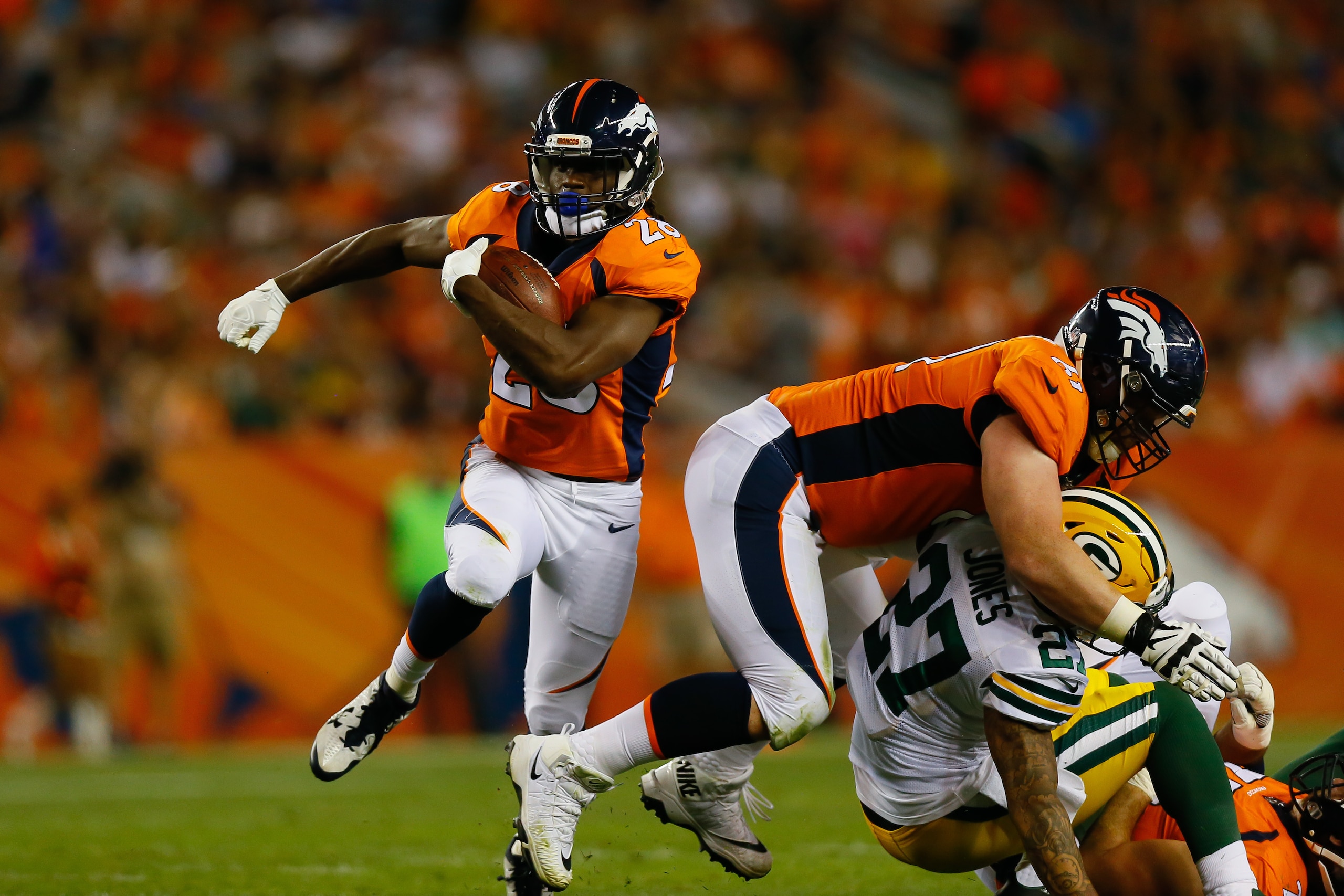DENVER, CO - AUGUST 26:  Running back Jamaal Charles #28 of the Denver Broncos runs with the football for a first down in the second quarter of a Preseason game against the Green Bay Packers at Sports Authority Field at Mile High on August 26, 2017 in Den