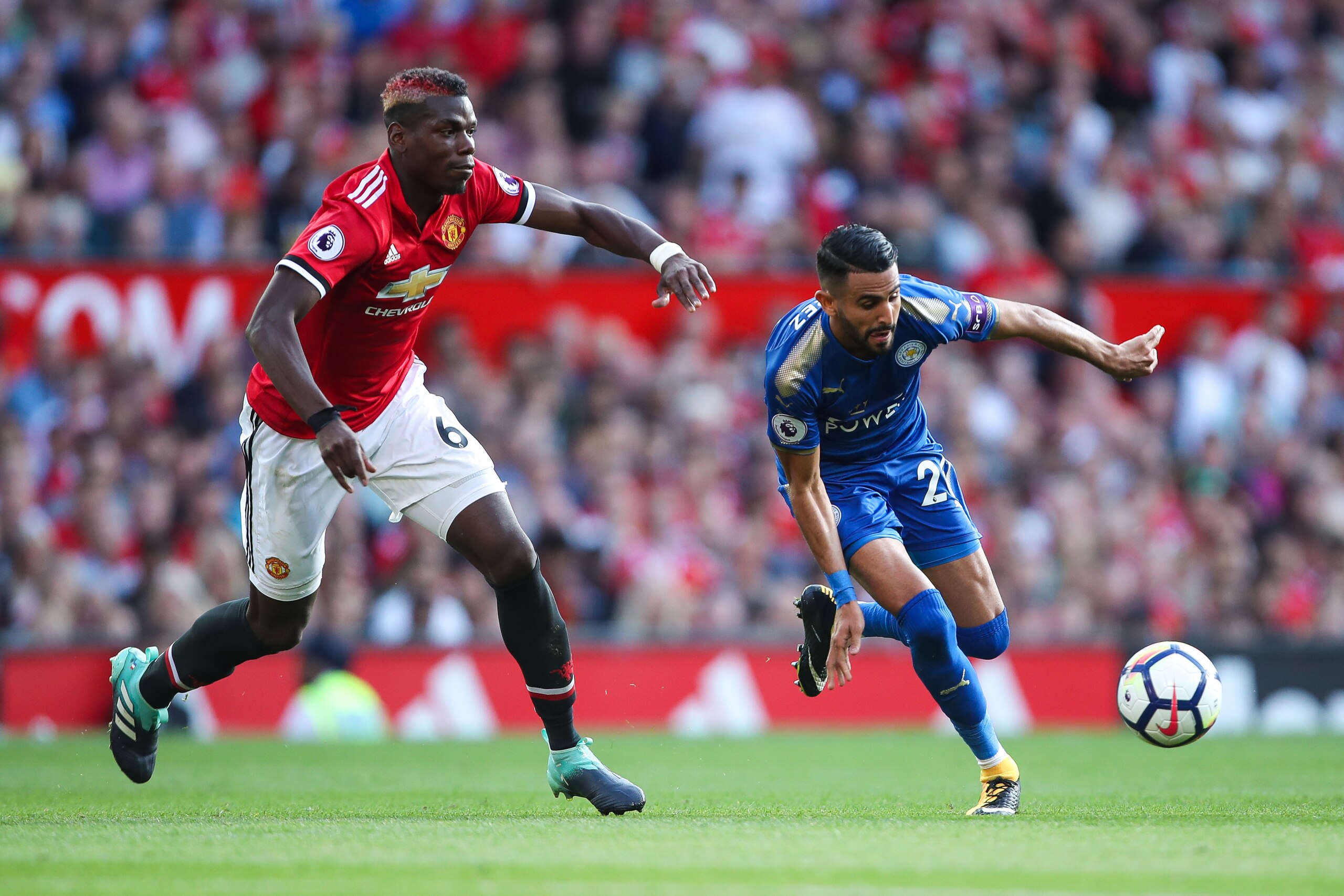 MANCHESTER, ENGLAND - AUGUST 26: Paul Pogba of Manchester United and Riyad Mahrez of Leicester City during the Premier League match between Manchester United and Leicester City at Old Trafford on August 26, 2017 in Manchester, England. (Photo by Robbie Ja