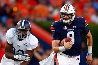 AUBURN, AL - SEPTEMBER 2:  Quarterback Jarrett Stidham #8 of the Auburn Tigers scrambles away from defensive end Raymond Johnson III #92 of the Georgia Southern Eagles during the first quarter of an NCAA college football game at Jordan Hare Stadium on Sat