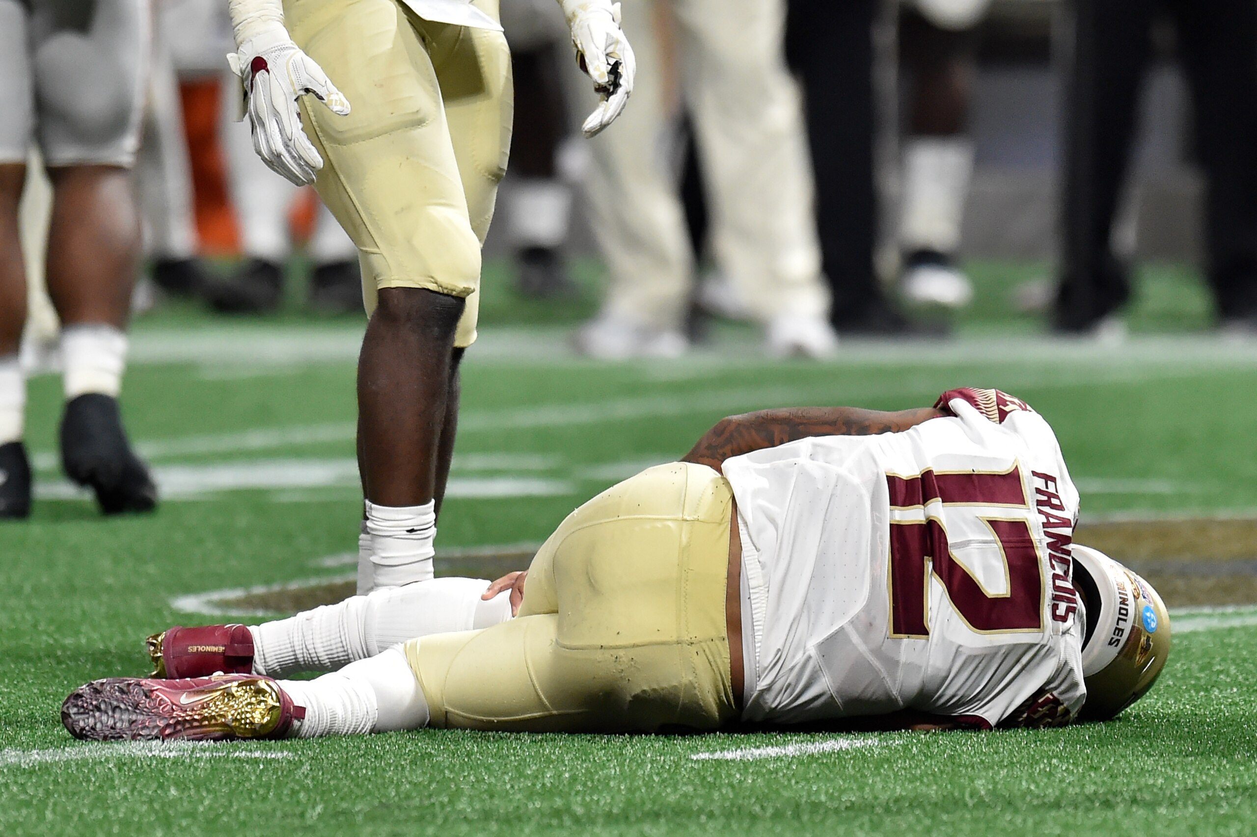 ATLANTA, GA - SEPTEMBER 02:  Deondre Francois #12 of the Florida State Seminoles hold his left leg after being injured in the fourth quarter of their game against the Alabama Crimson Tide at Mercedes-Benz Stadium on September 2, 2017 in Atlanta, Georgia. 