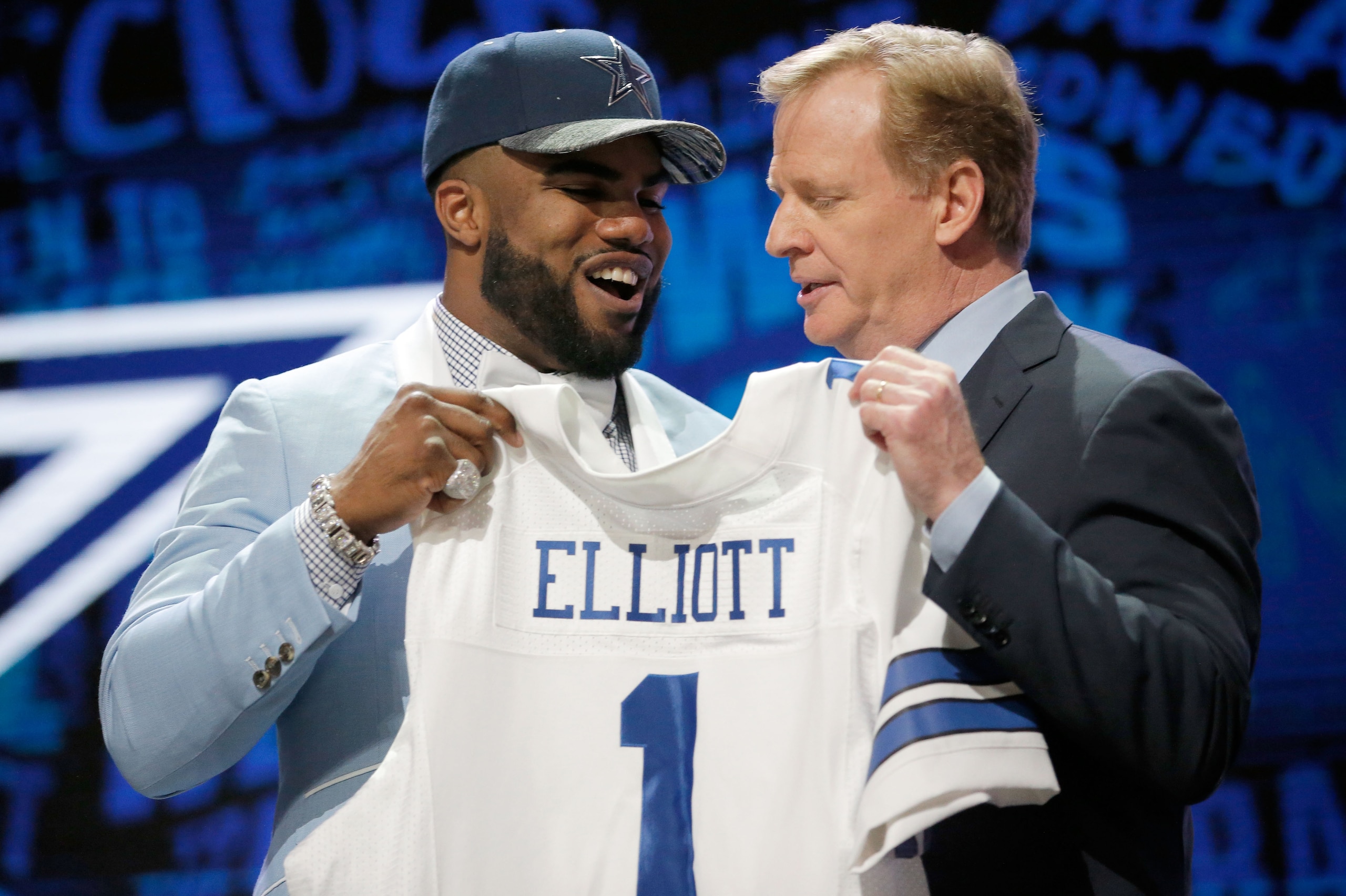 CHICAGO, IL - APRIL 28:  (L-R) Ezekiel Elliott of Ohio State holds up a jersey with NFL Commissioner Roger Goodell after being picked #4 overall by the Dallas Cowboys during the first round of the 2016 NFL Draft at the Auditorium Theatre of Roosevelt Univ