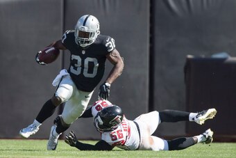 September 18, 2016; Oakland, CA, USA; Oakland Raiders running back Jalen Richard (30) runs with the football past Atlanta Falcons linebacker Sean Weatherspoon (56) during the third quarter at Oakland Coliseum. The Falcons defeated the Raiders 35-28. Manda