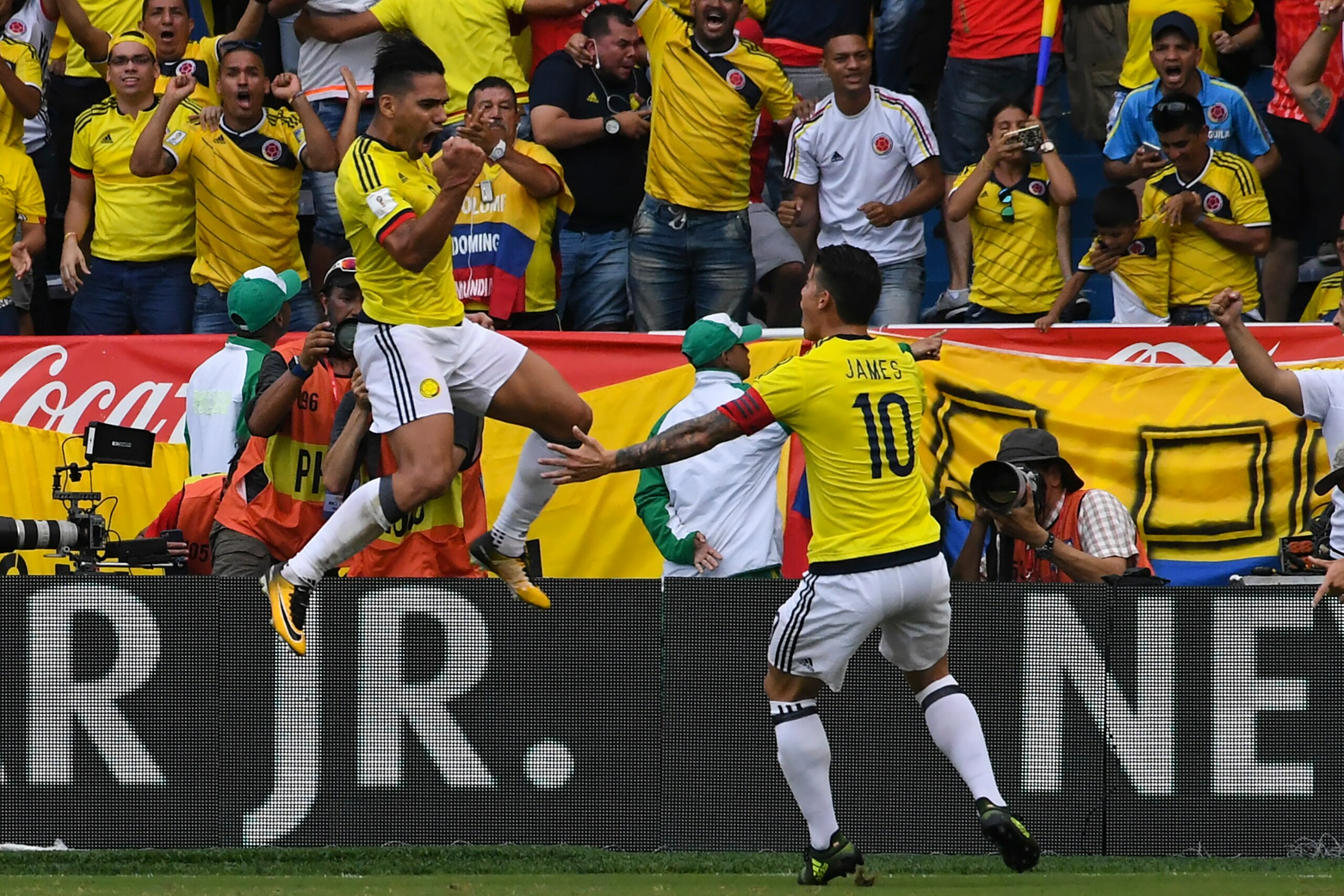 Colombia's Radamel Falcao (L) celebrates with teammate James Rodriguez after scoring against Brazil during their 2018 World Cup football qualifier match, in Barranquilla, Colombia, on September 5, 2017. / AFP PHOTO / Luis ACOSTA        (Photo credit shoul