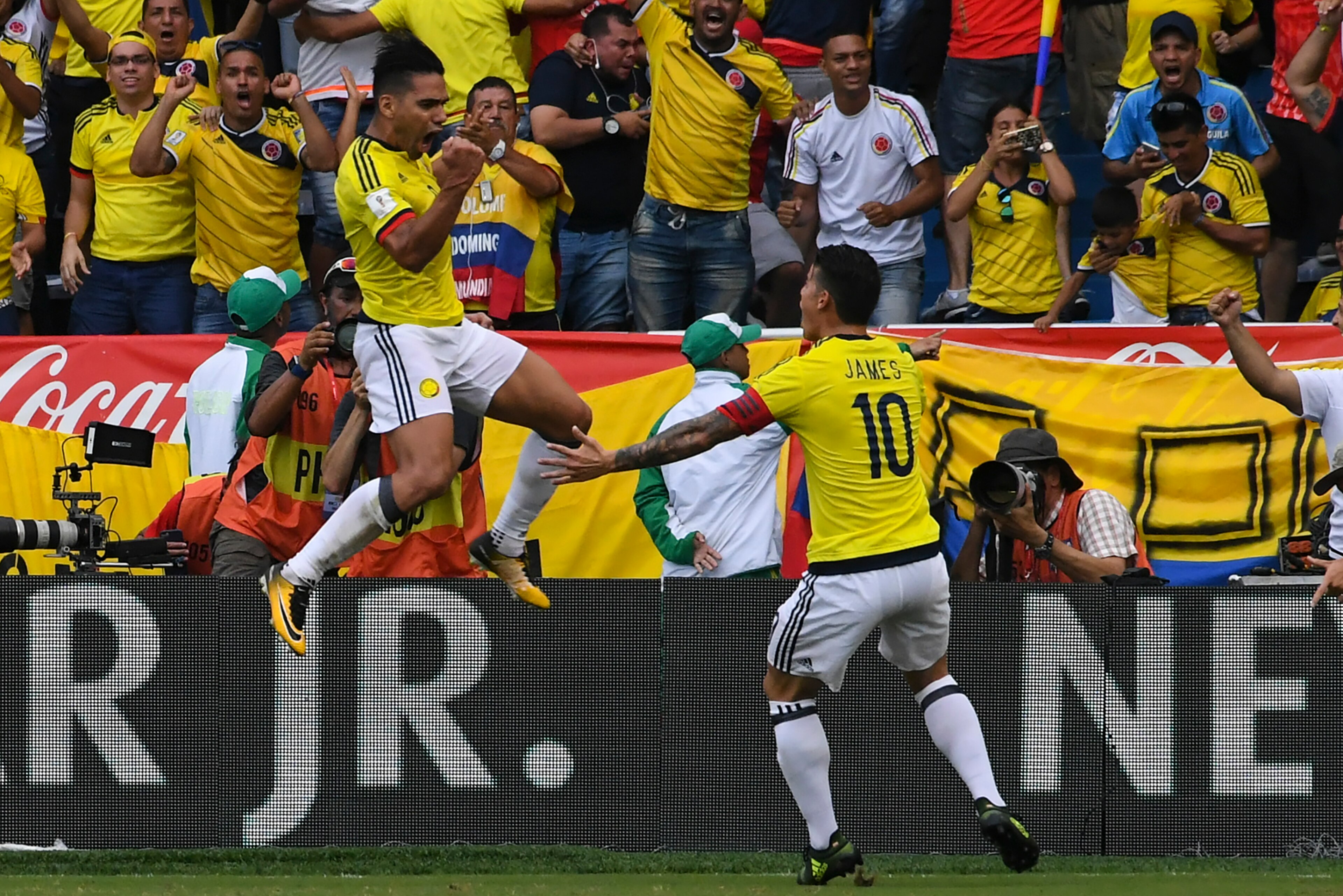 Colombia's Radamel Falcao (L) celebrates with teammate James Rodriguez after scoring against Brazil during their 2018 World Cup football qualifier match, in Barranquilla, Colombia, on September 5, 2017. / AFP PHOTO / Luis ACOSTA        (Photo credit shoul