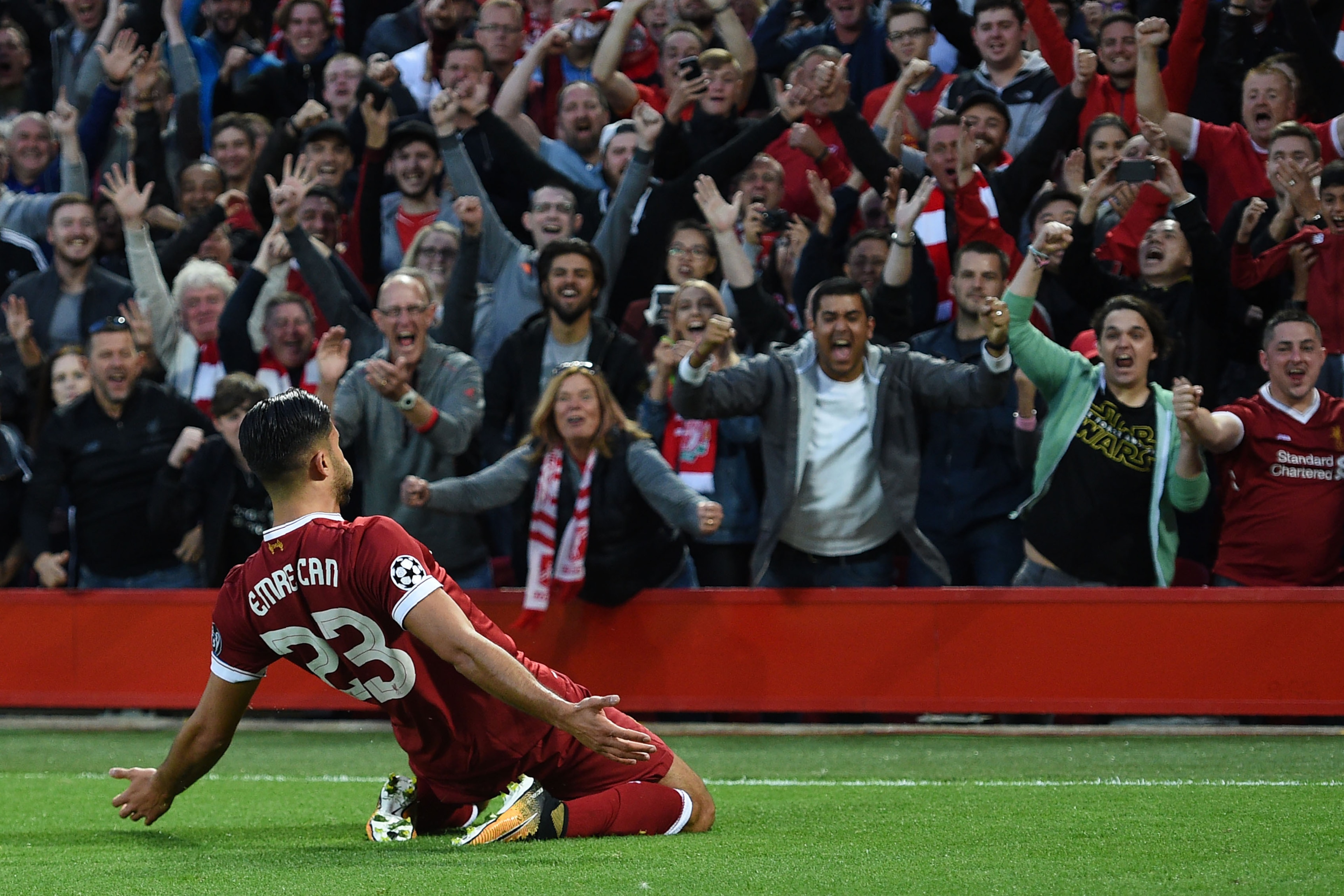 Liverpool's German midfielder Emre Can celebrates with teammates scoring the team's first goal during the Champions League qualifier, second leg match between Liverpool and Hoffenheim at Anfield stadium in Liverpool on August 23, 2017. / AFP PHOTO / Oli S