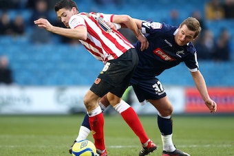 LONDON, ENGLAND - JANUARY 28: Harry Kane of Millwall tangles with Aaron Martin of Southampton during the FA Cup Fourth Round match between Millwall and Southampton at The Den on January 28, 2012 in London, England.  (Photo by Julian Finney/Getty Images)