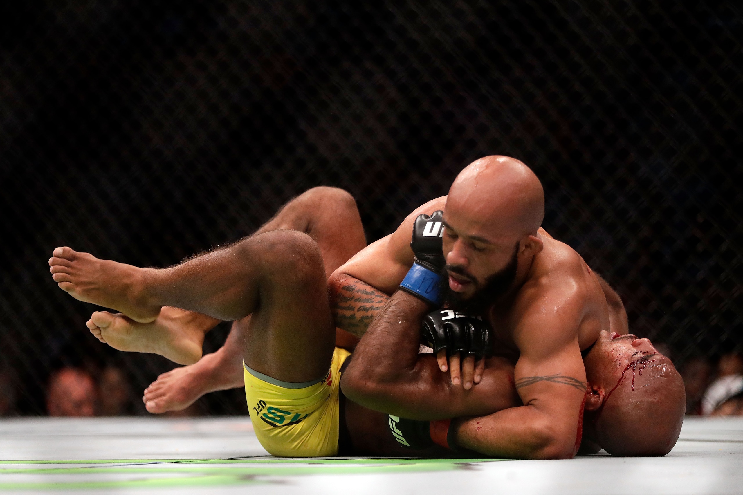 KANSAS CITY, MO - APRIL 15:  Demetrious Johnson (top) takes down Wilson Reis (bottom) during their Flyweight Championship bout on UFC Fight Night at the Sprint Center on April 15, 2017 in Kansas City, Missouri.  (Photo by Jamie Squire/Getty Images)