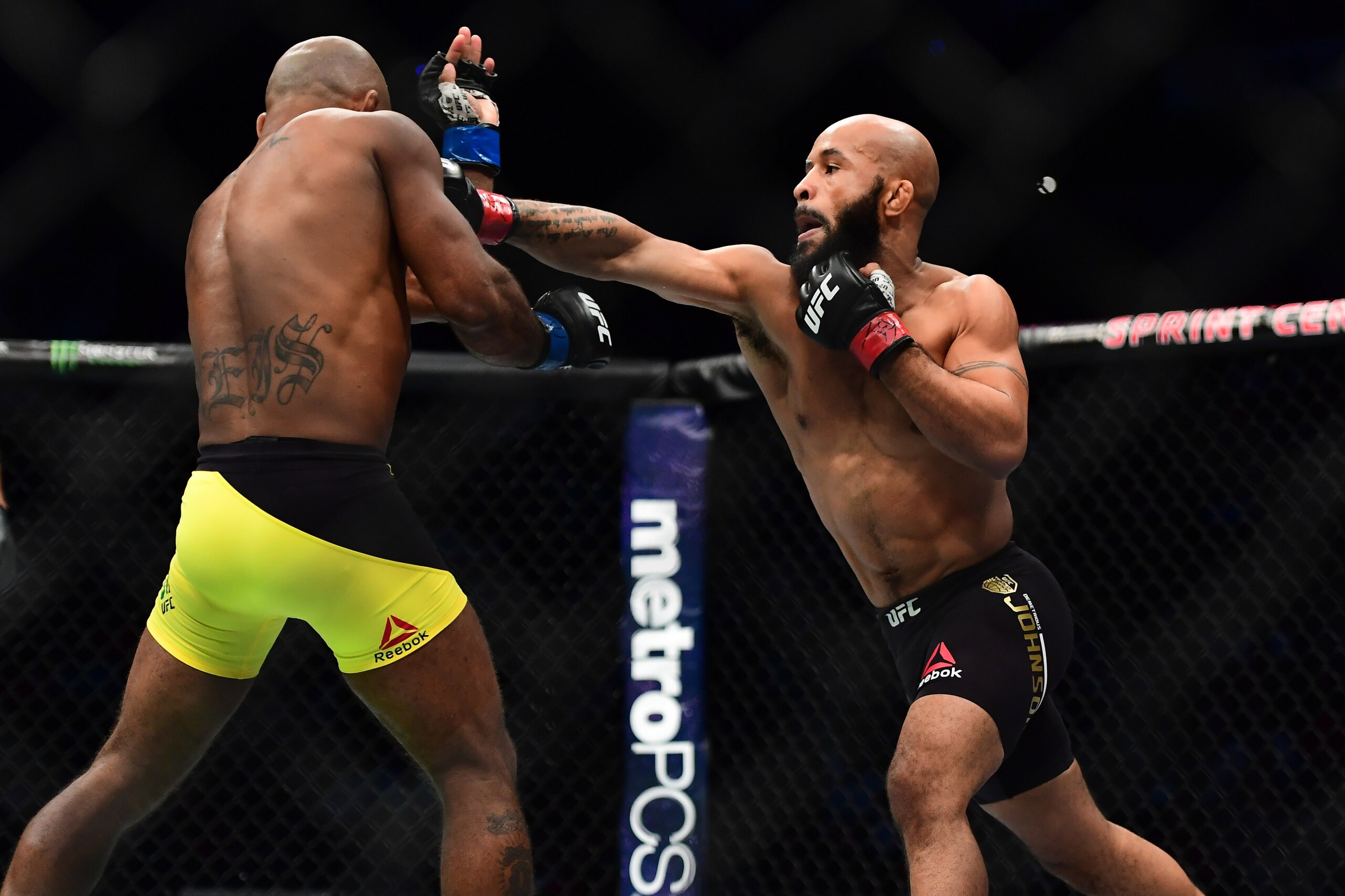 Apr 15, 2017; Kansas City, MO, USA; Demetrious Johnson (red) and Wilson Reis (blue) fight during UFC Fight Night at Sprint Center. Mandatory Credit: Ron Chenoy-USA TODAY Sports