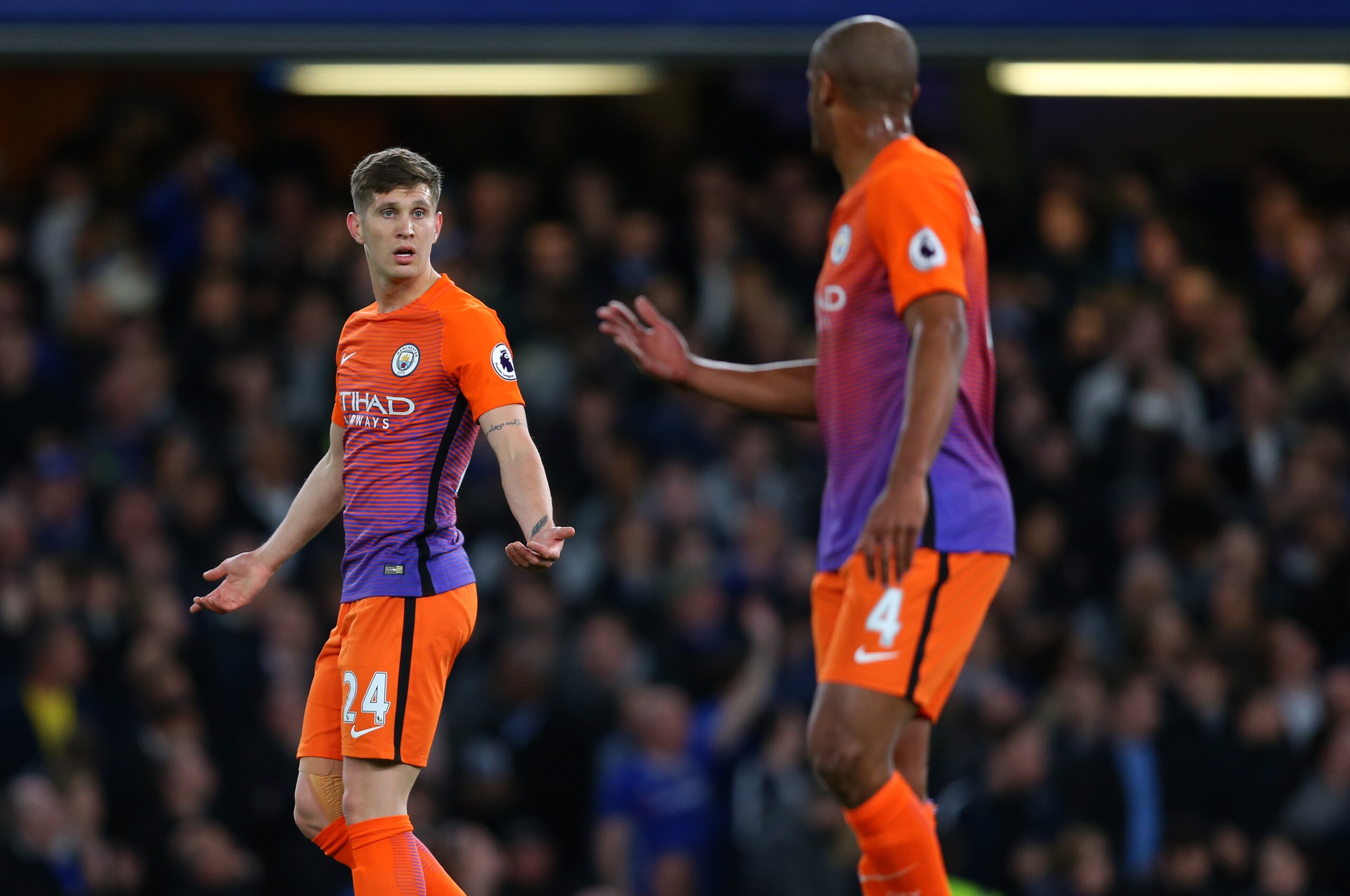 LONDON, ENGLAND - APRIL 05: John Stones of Manchester City shrugs his shoulders at Vincent Kompany of Manchester City during the Premier League match between Chelsea and Manchester City at Stamford Bridge on April 5, 2017 in London, England. (Photo by Cat