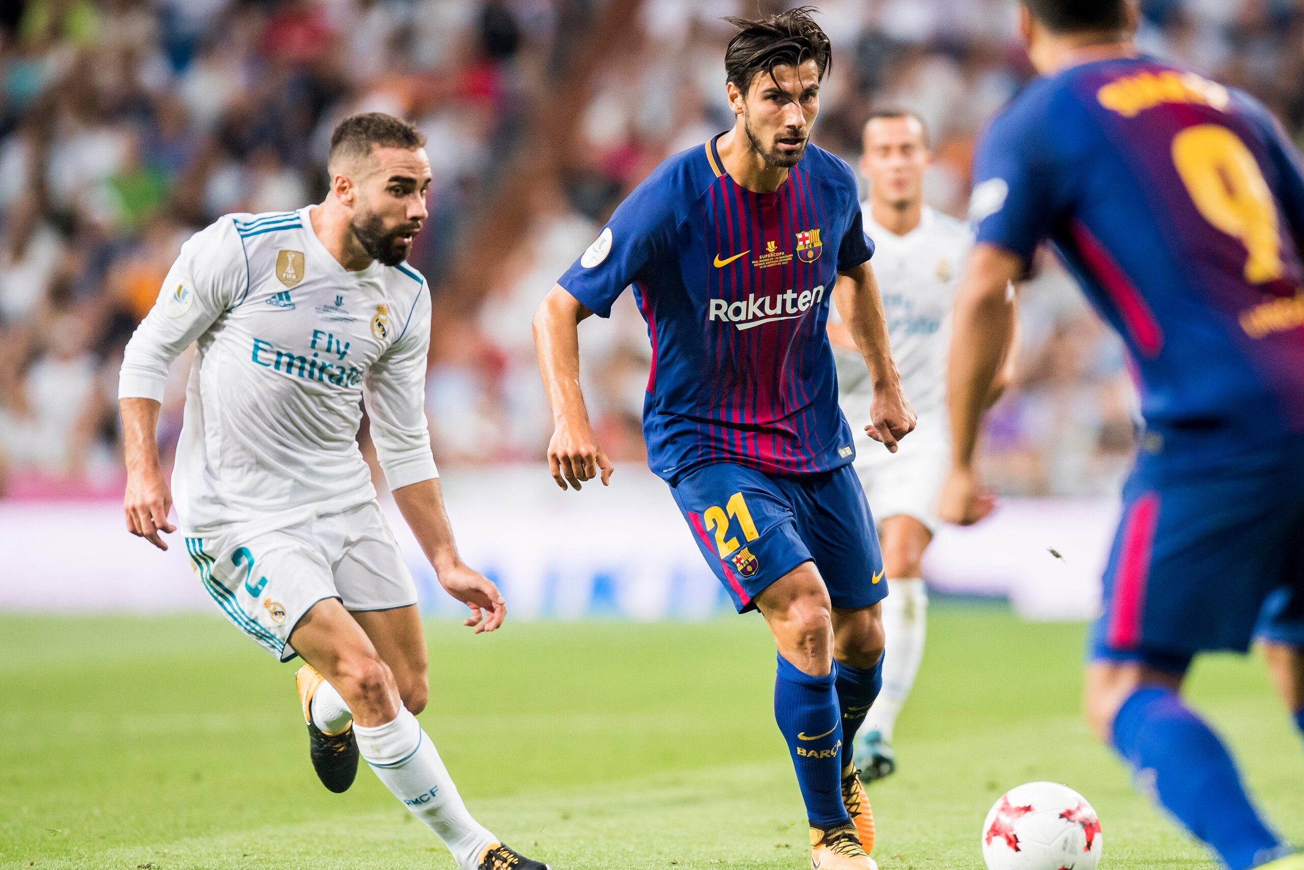 MADRID, SPAIN - AUGUST 16 - Andre Filipe Tavares Gomes (r) of FC Barcelona is followed by Daniel Carvajal Ramos of Real Madrid during their Supercopa de Espana Final 2nd Leg match between Real Madrid and FC Barcelona at the Estadio Santiago Bernabeu on 16 MADRID, SPAIN - AUGUST 16 - Andre Filipe Tavares Gomes (r) of FC Barcelona is followed by Daniel Carvajal Ramos of Real Madrid during their Supercopa de Espana Final 2nd Leg match between Real Madrid and FC Barcelona at the Estadio Santiago Bernabeu on 16