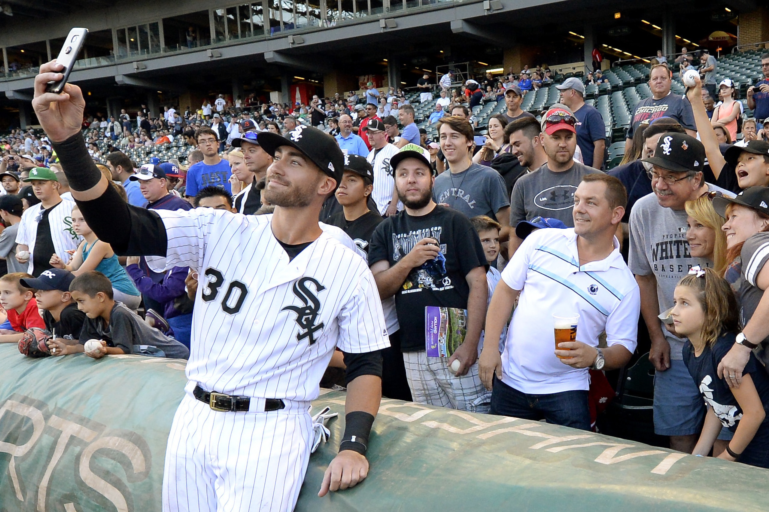 CHICAGO - AUGUST 22:  Nicky Delmonico #30 of the Chicago White Sox takes a selfie with fans prior to the game against the Minnesota Twins on August 22, 2017 at Guaranteed Rate Field in Chicago, Illinois.  The White Sox defeated the VISITOR 0-0.  (Photo by