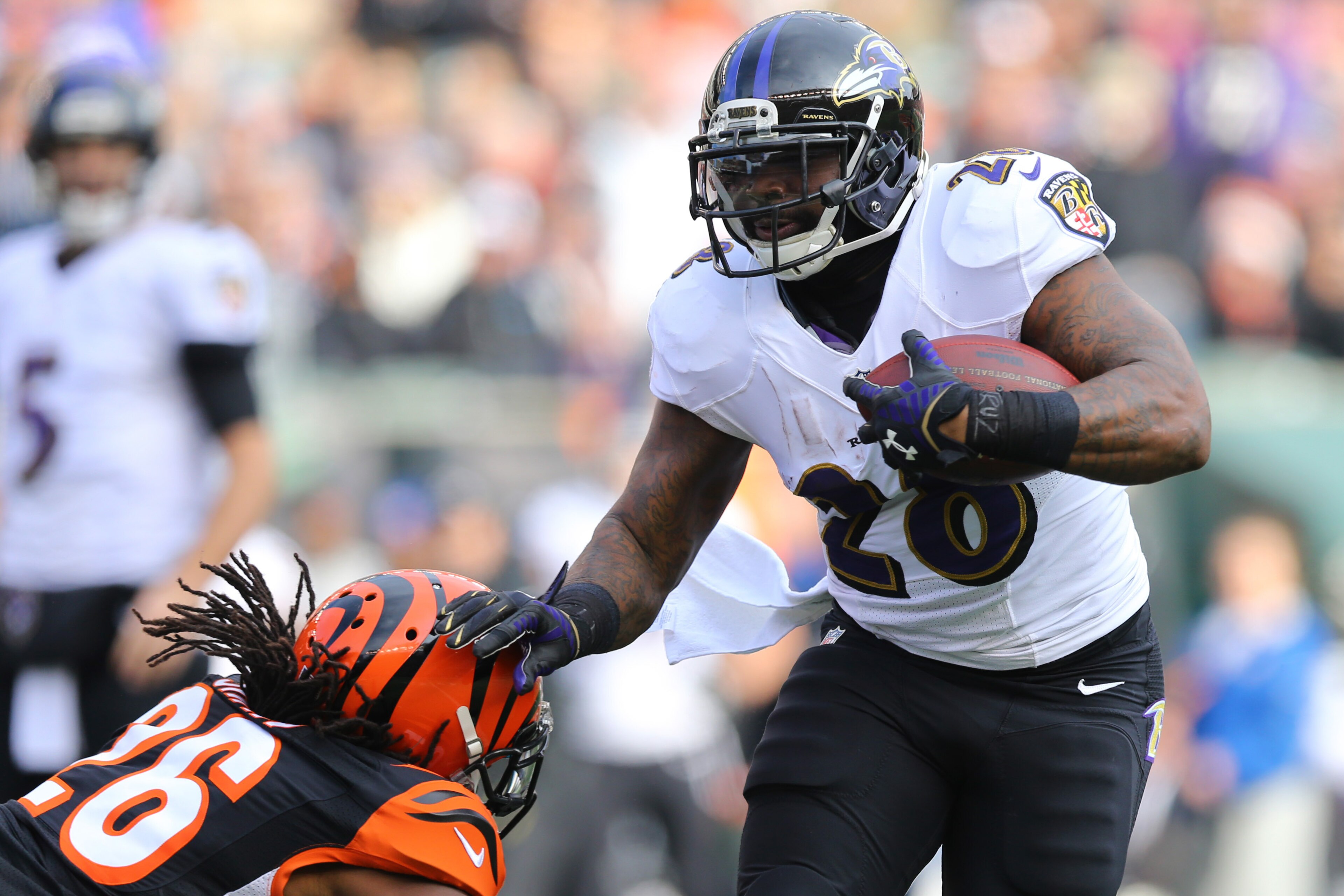 Jan 1, 2017; Cincinnati, OH, USA; Baltimore Ravens running back Terrance West (28) breaks a tackle from Cincinnati Bengals cornerback Josh Shaw (26) at Paul Brown Stadium. The Bengals won 27-10. Mandatory Credit: Aaron Doster-USA TODAY Sports