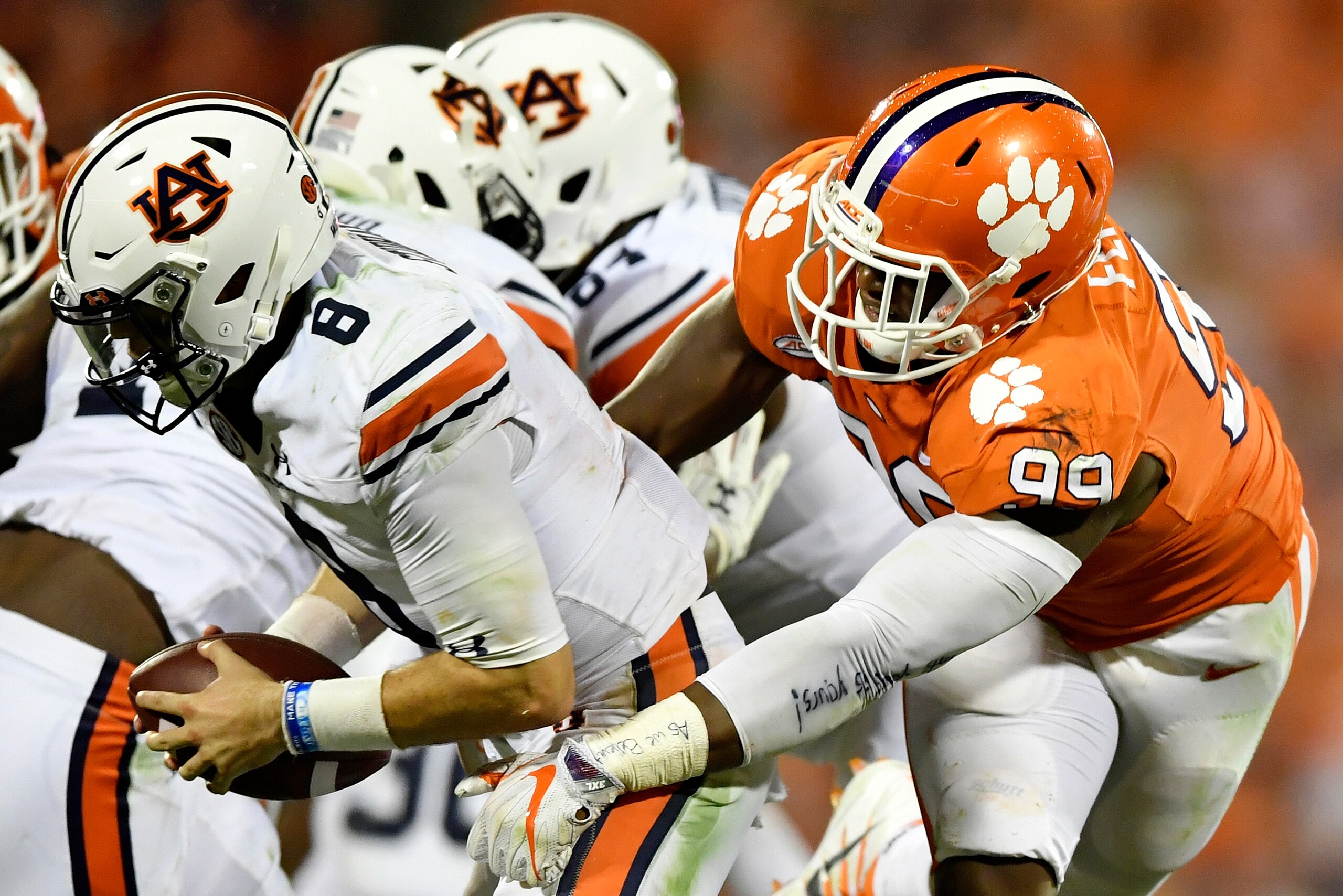 CLEMSON, SC - SEPTEMBER 09:  Quarterback Jarrett Stidham #8 of the Auburn Tigers eludes defensive end Clelin Ferrell #99 of the Clemson Tigers during the football game at Memorial Stadium on September 9, 2017 in Clemson, South Carolina. (Photo by Mike Com
