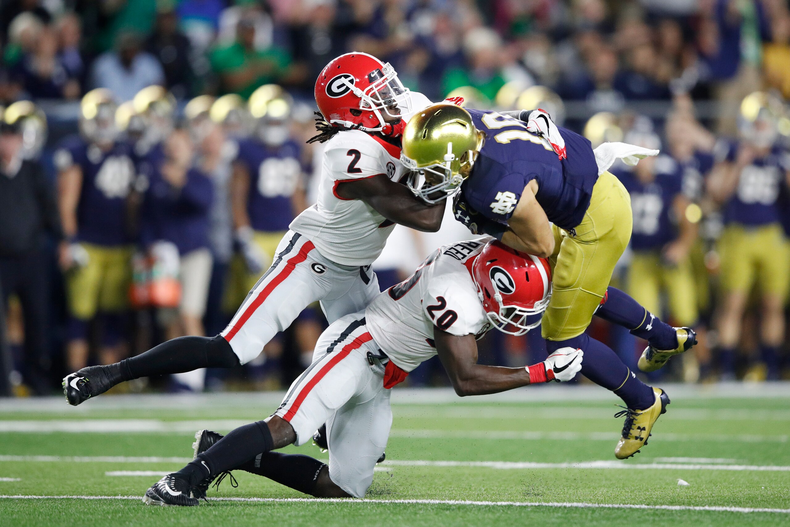 SOUTH BEND, IN - SEPTEMBER 09: Richard LeCounte III #2 and J.R. Reed #20 of the Georgia Bulldogs tackle Chris Finke #10 of the Notre Dame Fighting Irish in the fourth quarter of a game at Notre Dame Stadium on September 9, 2017 in South Bend, Indiana. Geo