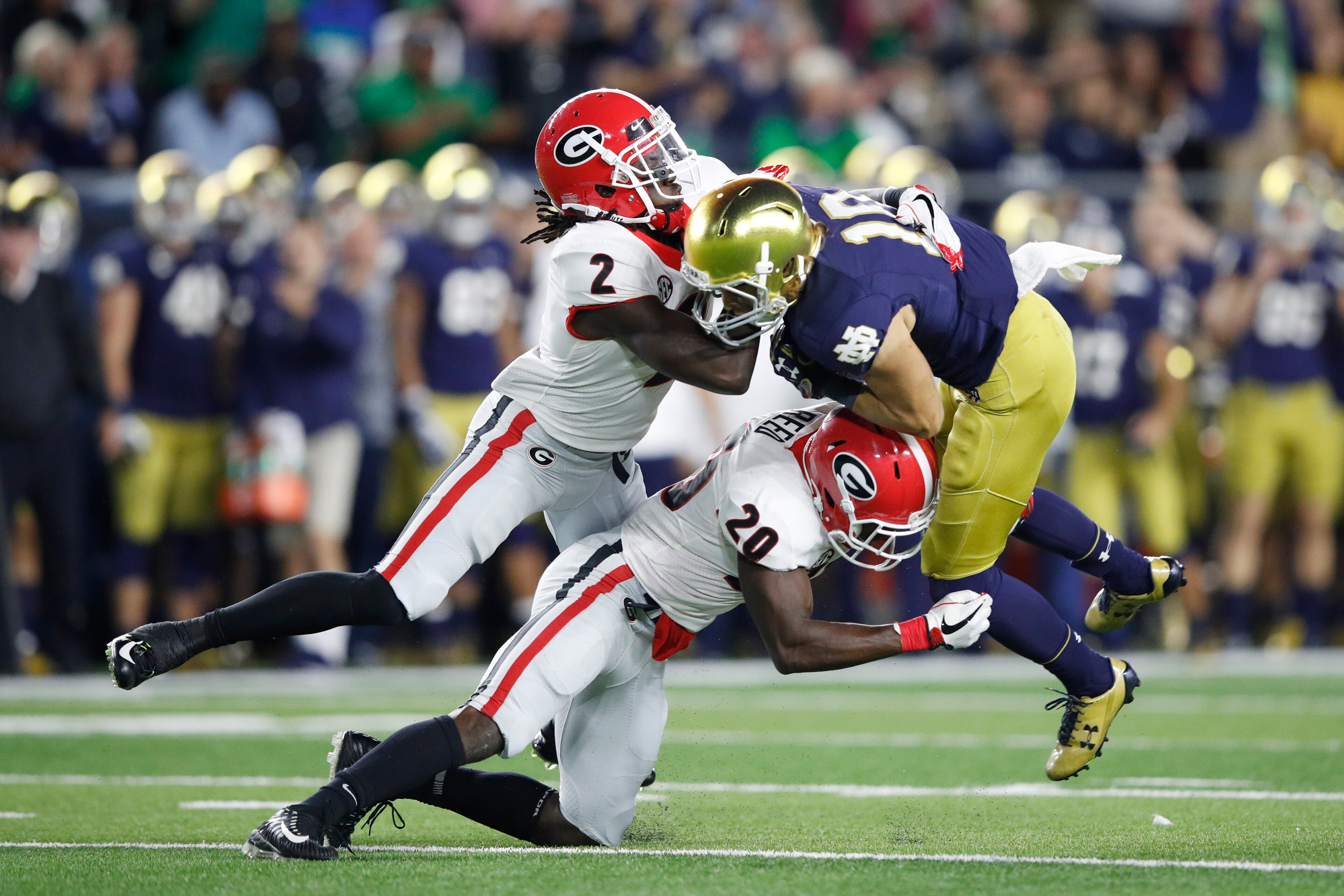 SOUTH BEND, IN - SEPTEMBER 09: Richard LeCounte III #2 and J.R. Reed #20 of the Georgia Bulldogs tackle Chris Finke #10 of the Notre Dame Fighting Irish in the fourth quarter of a game at Notre Dame Stadium on September 9, 2017 in South Bend, Indiana. Geo
