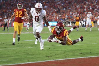 LOS ANGELES, CA - SEPTEMBER 09: (EDITORS NOTE: Retransmission with alternate crop.) Deontay Burnett #80 of the USC Trojans dives into the end zone during the second quarter to score a touchdown against the Stanford Cardinal at Los Angeles Memorial Coliseu