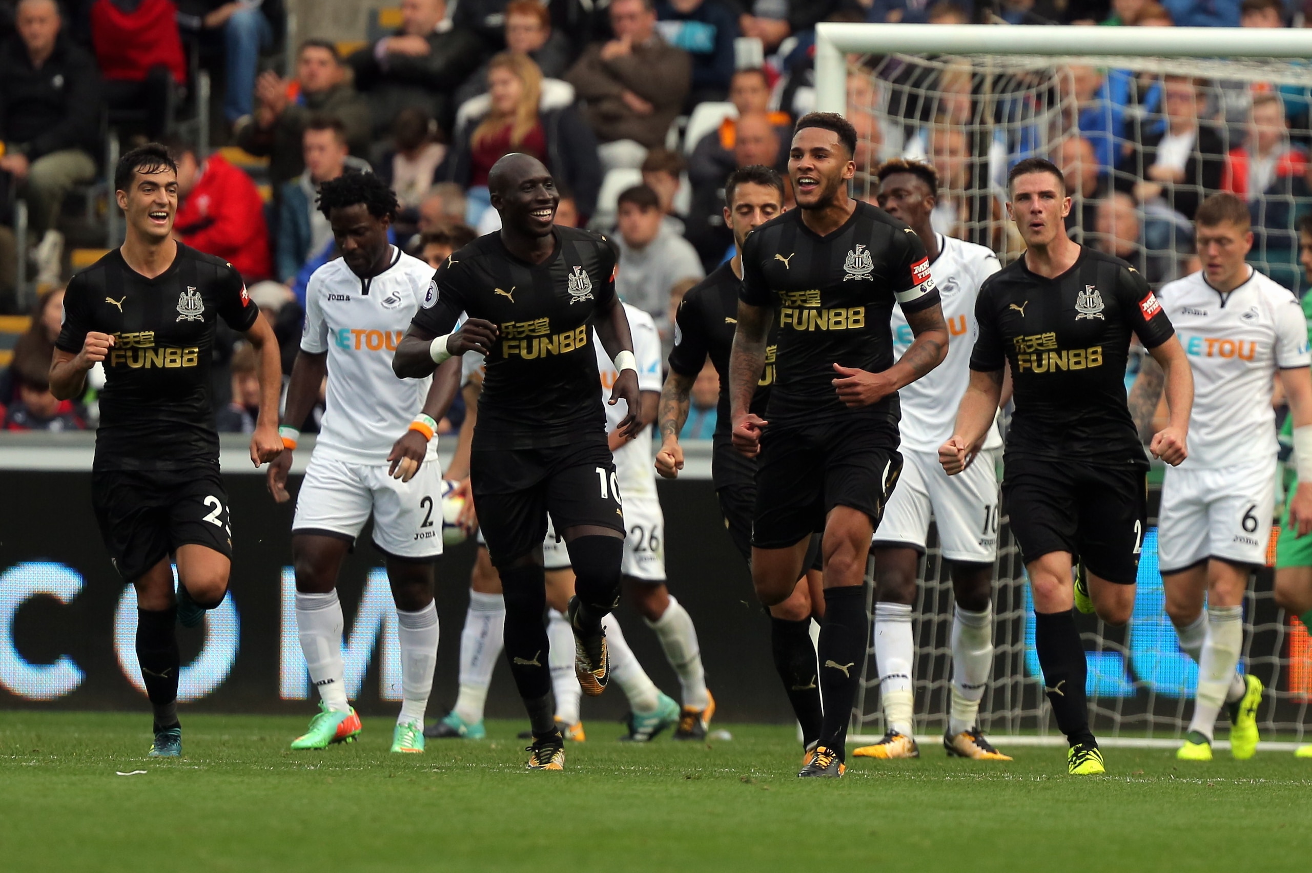 SWANSEA, WALES - SEPTEMBER 10: Jamaal Lascelles of Newcastle United (C) celebrates his goal with team mates during the Premier League match between Swansea City and Newcastle United at The Liberty Stadium on September 10, 2017 in Swansea, Wales. (Photo by