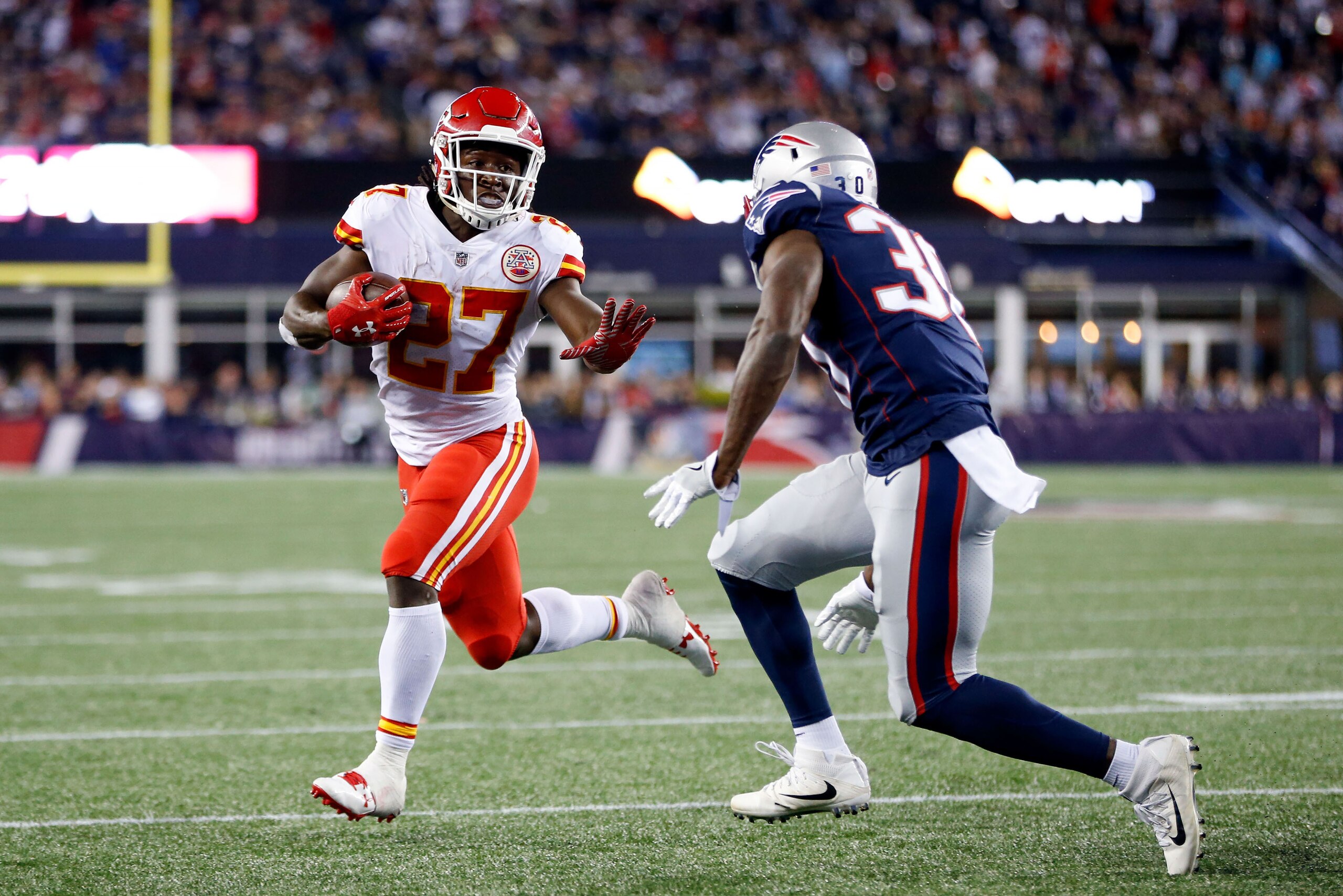 Sep 7, 2017; Foxborough, MA, USA;  Kansas City Chiefs running back Kareem Hunt (27) runs the ball for a touchdown against New England Patriots free safety Duron Harmon (30) during the fourth quarter at Gillette Stadium. Mandatory Credit: Greg M. Cooper-US