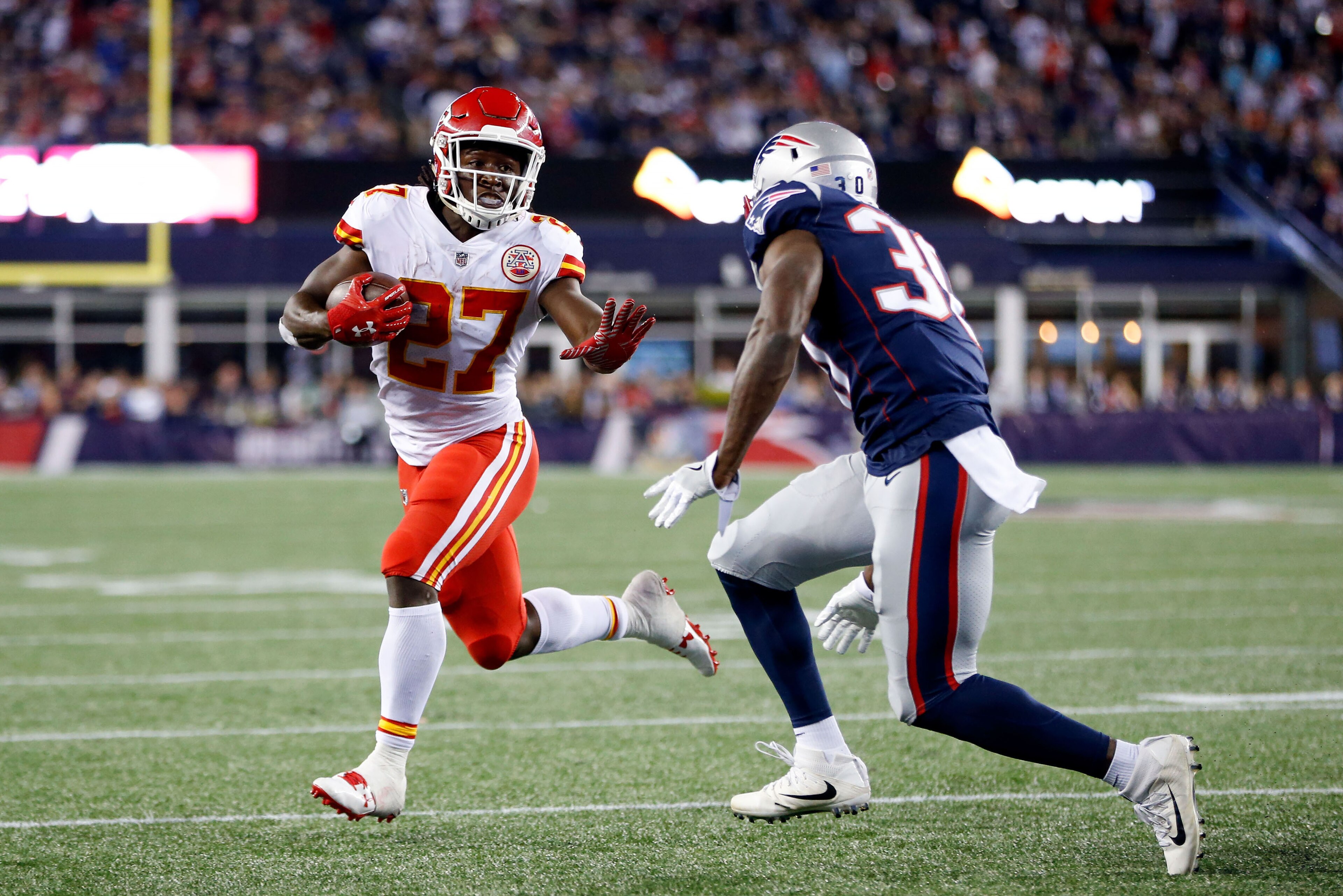 Sep 7, 2017; Foxborough, MA, USA;  Kansas City Chiefs running back Kareem Hunt (27) runs the ball for a touchdown against New England Patriots free safety Duron Harmon (30) during the fourth quarter at Gillette Stadium. Mandatory Credit: Greg M. Cooper-US