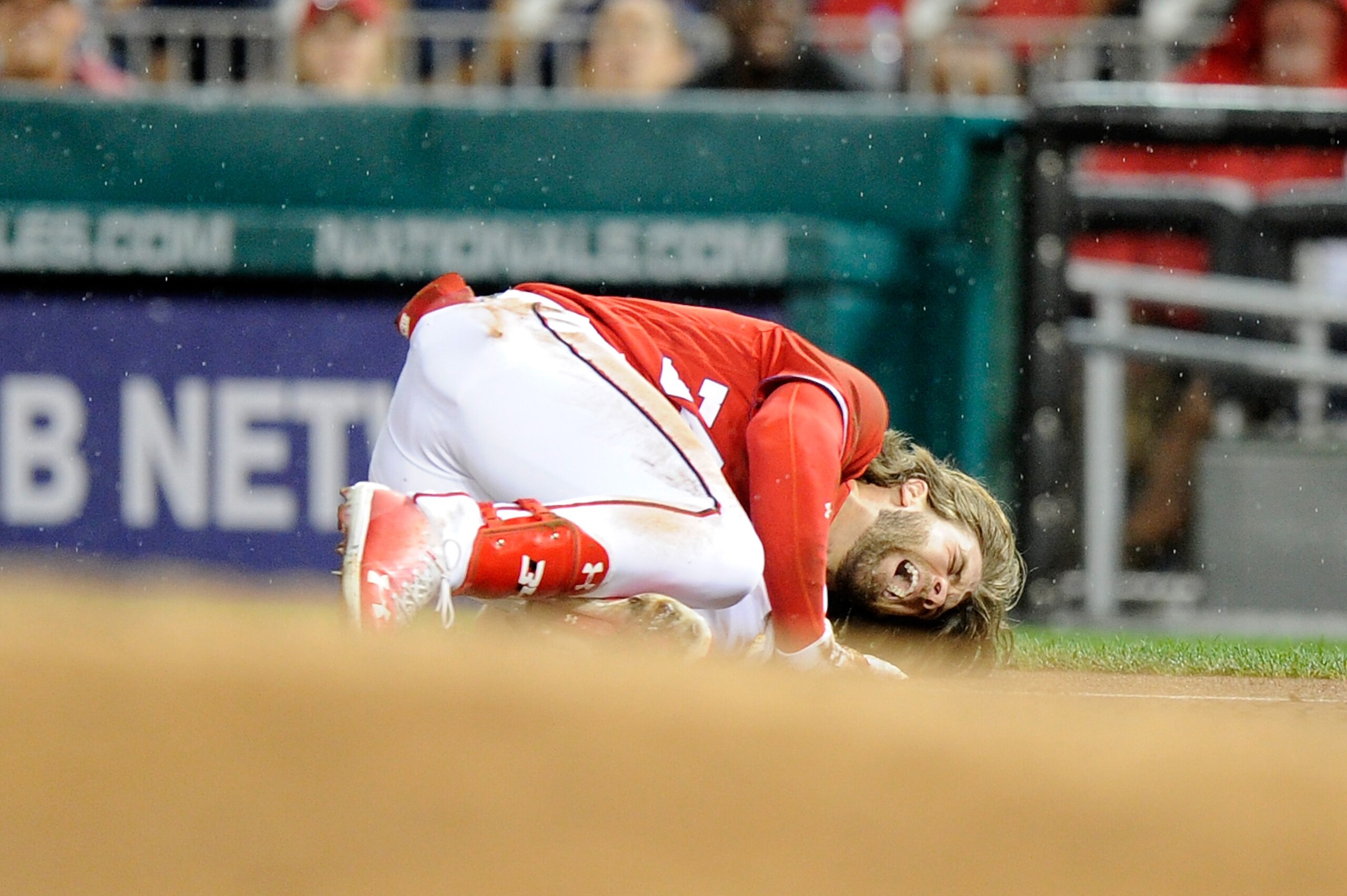WASHINGTON, DC - AUGUST 12: Bryce Harper #34 of the Washington Nationals on the ground in pain after injuring his leg in the first inning against the San Francisco Giants at Nationals Park on August 12, 2017 in Washington, DC.  (Photo by Greg Fiume/Getty 
