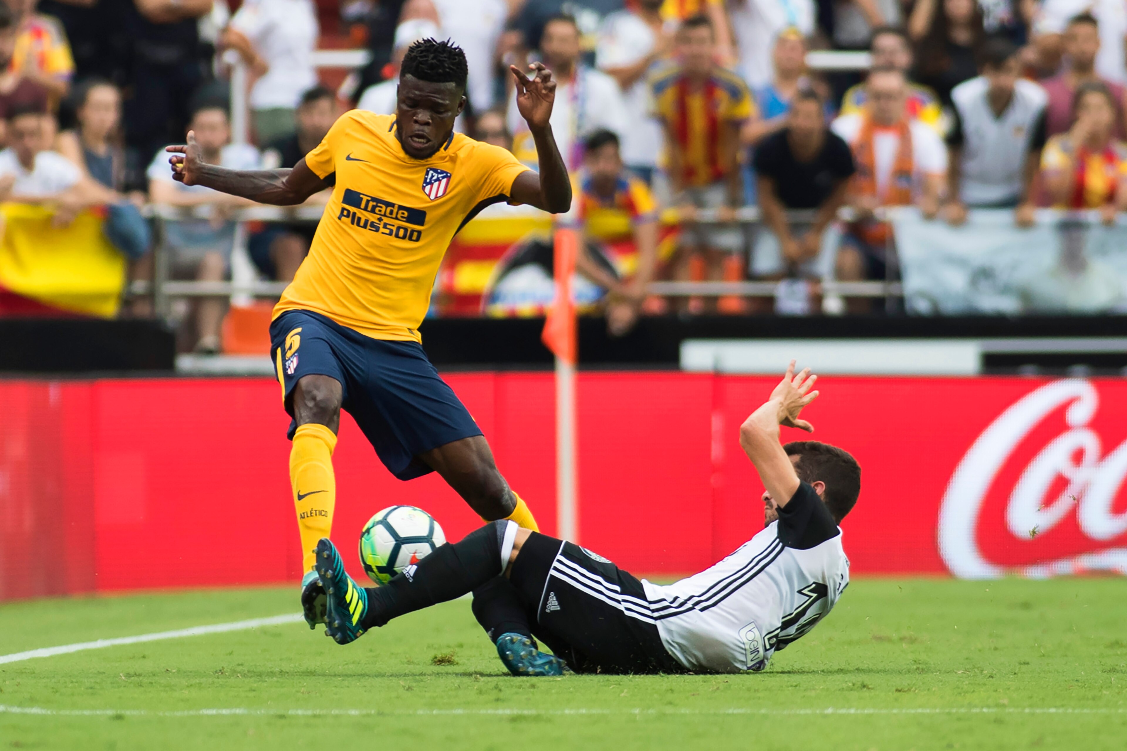 Atletico de Madrid's Ghanaian midfielder Thomas Partey (L) vies with Valencia's defender from Spain Jose Luis Gaya Pena during the Spanish Liga football match Valencia CF vs Club Atletico de Madrid at the Mestalla stadium in Valencia on September 9, 2017.