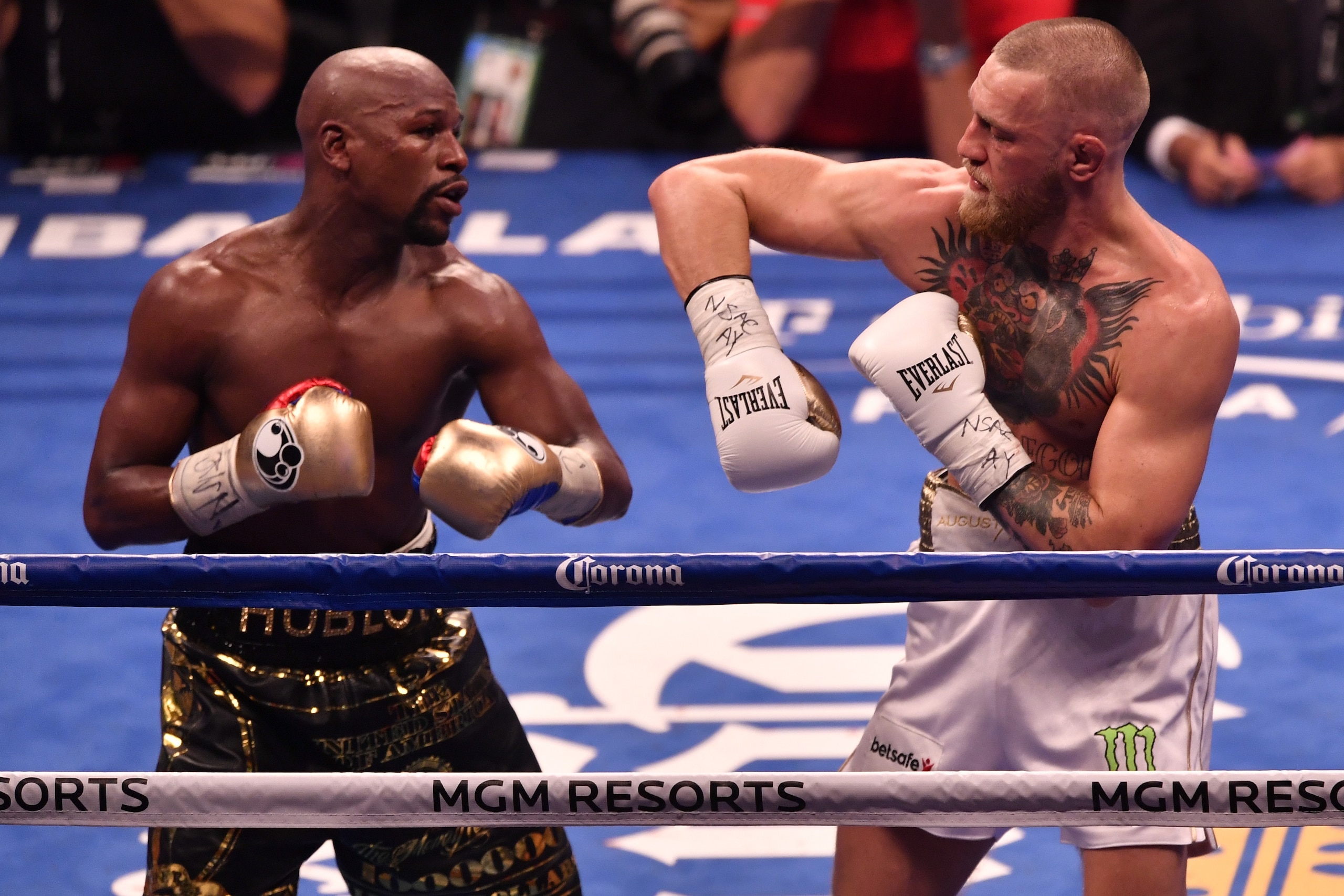 LAS VEGAS, NV - AUGUST 26:  (L-R) Floyd Mayweather Jr. and Conor McGregor exchange punches in their super welterweight boxing match at T-Mobile Arena on August 26, 2017 in Las Vegas, Nevada. Mayweather won by 10th-round TKO. (Photo by Jeff Bottari/Zuffa L