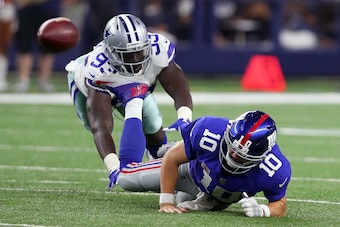 ARLINGTON, TX - SEPTEMBER 10:  Benson Mayowa #93 of the Dallas Cowboys knocks Eli Manning #10 of the New York Giants to the turf in the fourth quarter at AT&T Stadium on September 10, 2017 in Arlington, Texas.  (Photo by Tom Pennington/Getty Images)