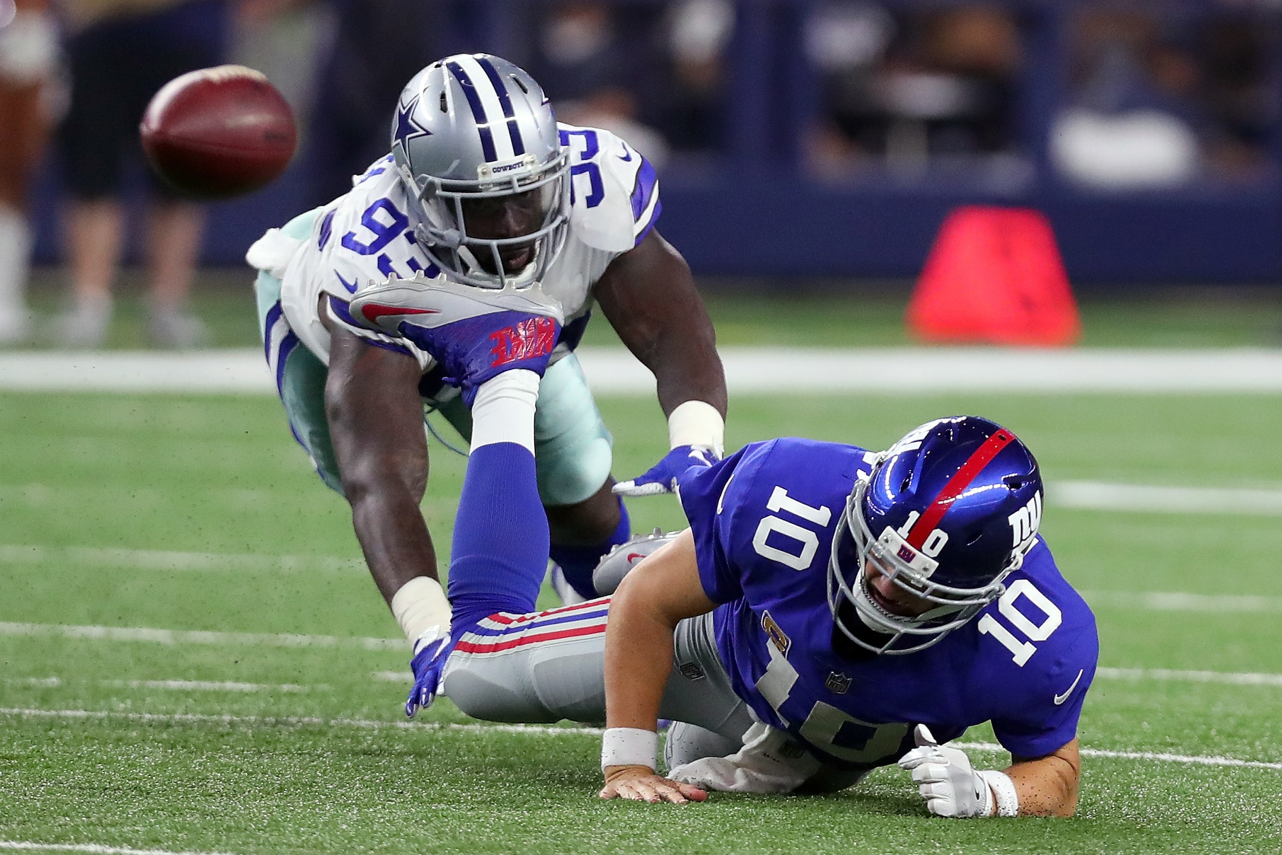 ARLINGTON, TX - SEPTEMBER 10: Benson Mayowa #93 of the Dallas Cowboys knocks Eli Manning #10 of the New York Giants to the turf in the fourth quarter at AT&T Stadium on September 10, 2017 in Arlington, Texas. (Photo by Tom Pennington/Getty Images) ARLINGTON, TX - SEPTEMBER 10: Benson Mayowa #93 of the Dallas Cowboys knocks Eli Manning #10 of the New York Giants to the turf in the fourth quarter at AT&T Stadium on September 10, 2017 in Arlington, Texas. (Photo by Tom Pennington/Getty Images)