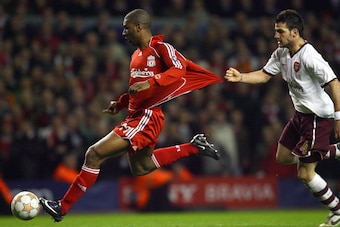 Liverpool's Dutch forward Ryan Babel (L) shrugs off Arsenal's Spanish midfielder Cesc Fabregas to score the fourth goal during their UEFA Champions League quater final second leg football match at Anfield, Liverpool, north-west England, on April 8, 2008. 