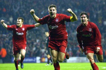 LIVERPOOL, UNITED KINGDOM:  Liverpool's Steven Gerard (c) flanked by John Arne Riise (l) and Harry Kew ll (r) celebrates scoring to make it 3-1 against Olympiakos CFP during their UEFA Champions League clash at Anfield, Liverpool08 December 2004. AFP phot