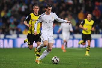 MADRID, SPAIN - APRIL 02: Gareth Bale of Real Madrid goes past Erik Durm of Borussia Dortmund during the UEFA Champions League Quarter Final first leg match between Real Madrid and Borussia Dortmund at Estadio Santiago Bernabeu on April 2, 2014 in Madrid,